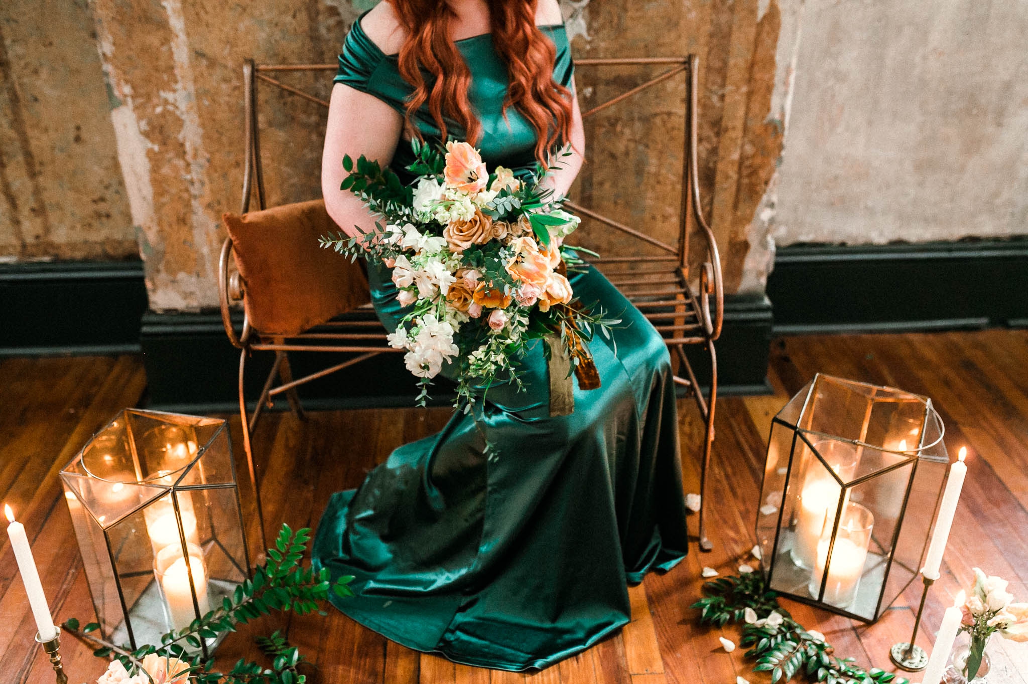 Detail shot of a red headed bride in a unique emerald wedding dress in front of a flower and candle set up inspiration - Bridal Session