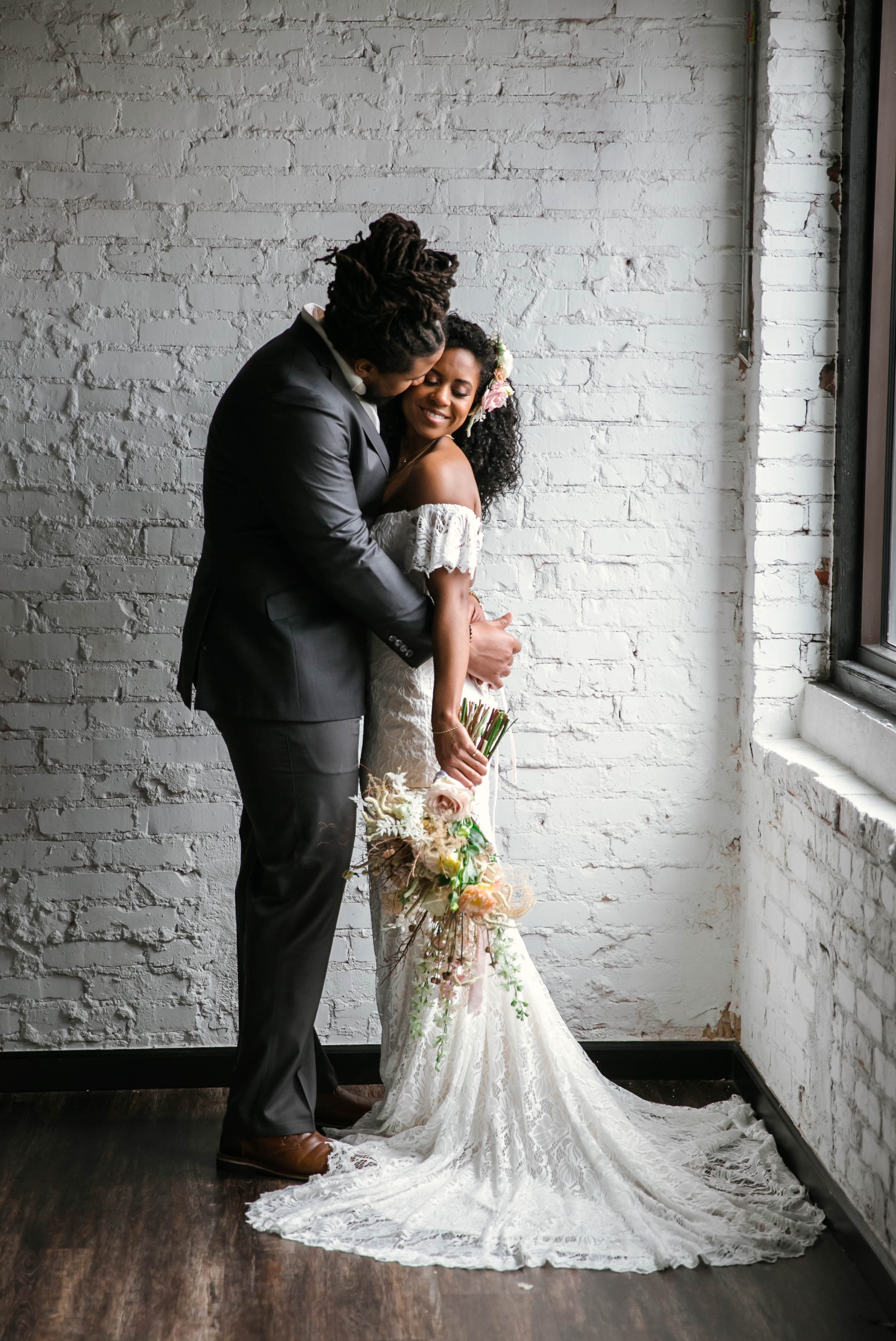  Indoor Wedding Portrait with natural light by a Window of an African American Black couple - Groom kisses the bride on the cheek - boho tropical inspiration by Honolulu, Oahu, Hawaii Wedding Photographer 