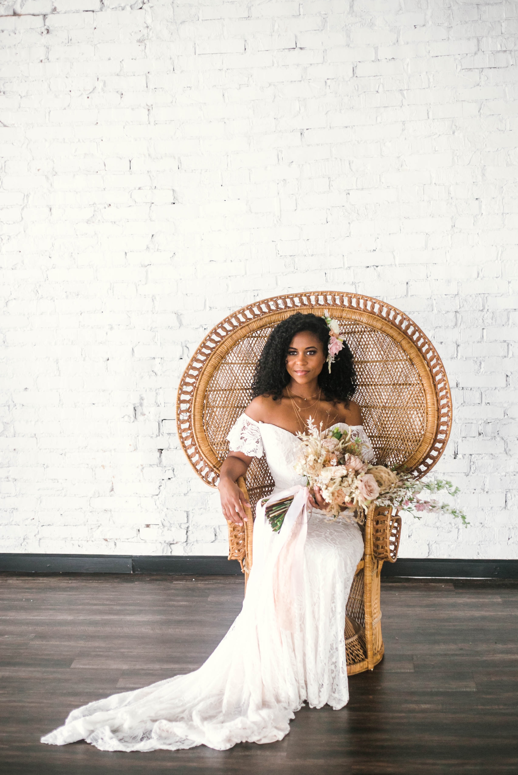  Indoor Wedding Portraits, shot with natural light - black love - african american bride sitting in a Midcentury Woven Wicker Peacock Chair in a boho wedding dress with a big bouquet  - tropical inspiration - honolulu, oahu, hawaii photographer 