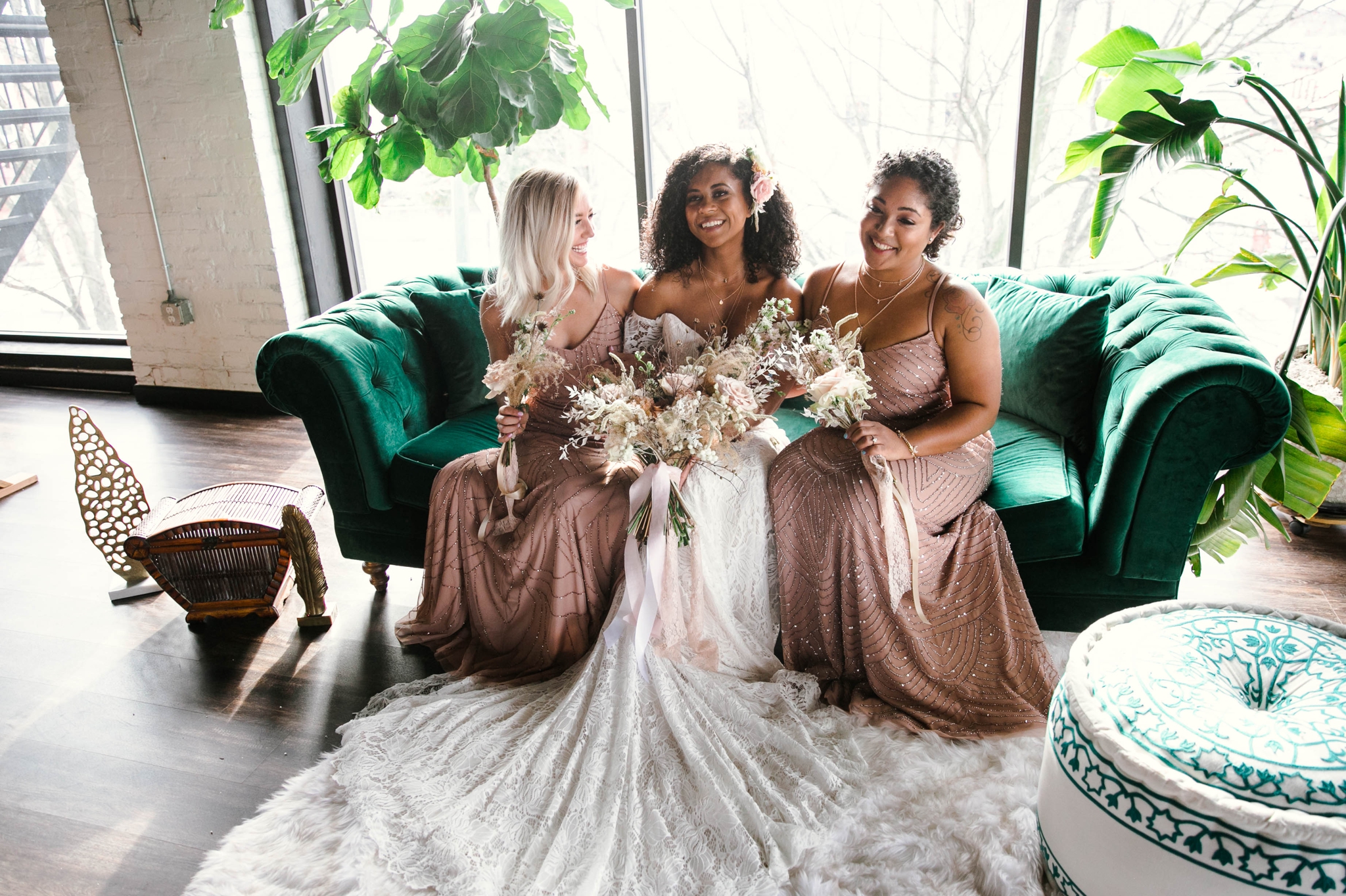  Indoor Natural light portrait of a black bride and her bridesmaids in a boho wedding dress with light pink bridesmaids dresses sitting on an emerald tufted sofa - flowers in natural african american hair - oahu hawaii wedding photographer 