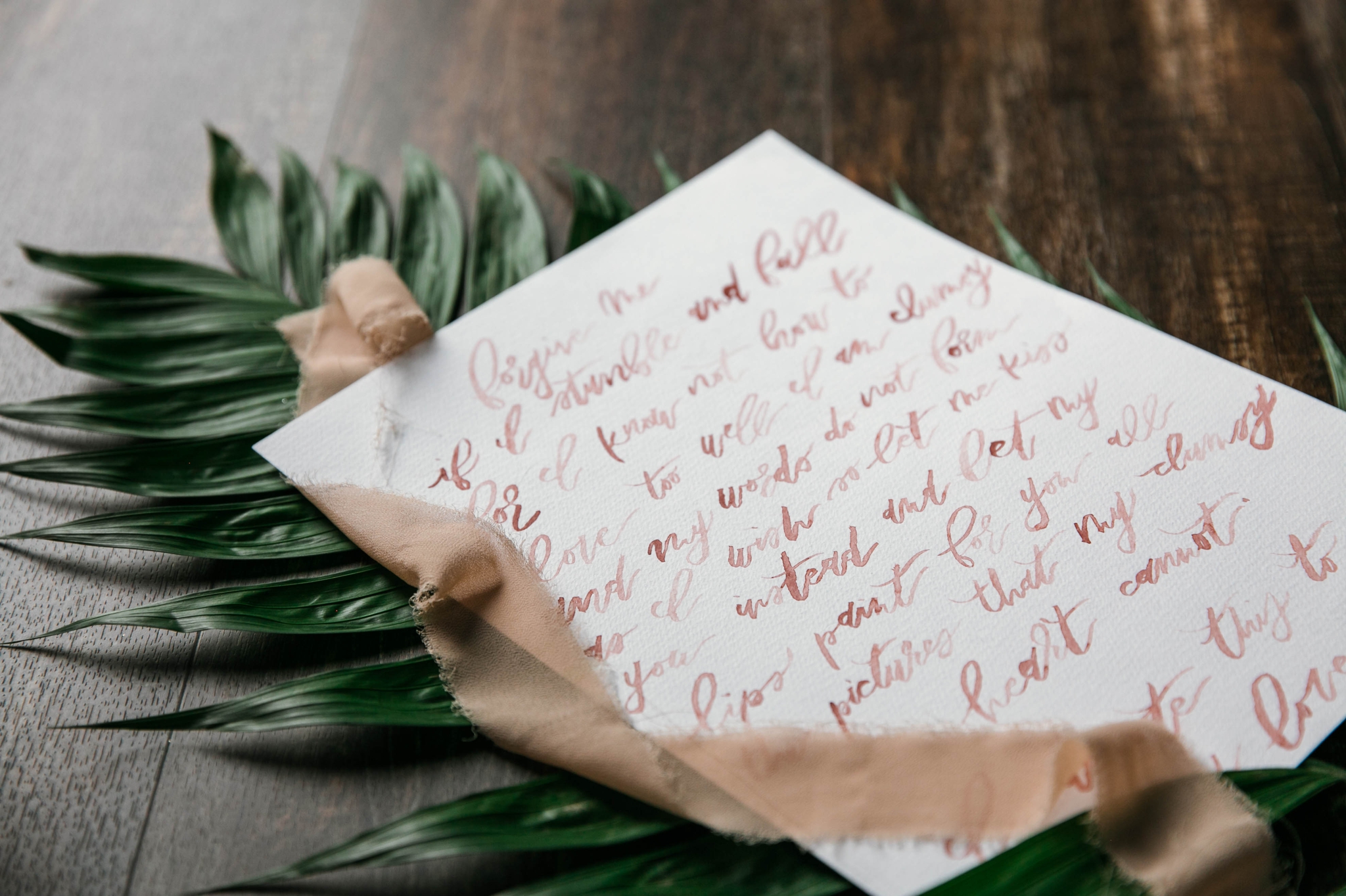  Lay flat of Wedding Vows with a tropical leave as the background with light pink ribbon styled by Johanna Dye Photography designed by Tortoise.Design - Oahu Hawaii Wedding Photographer 