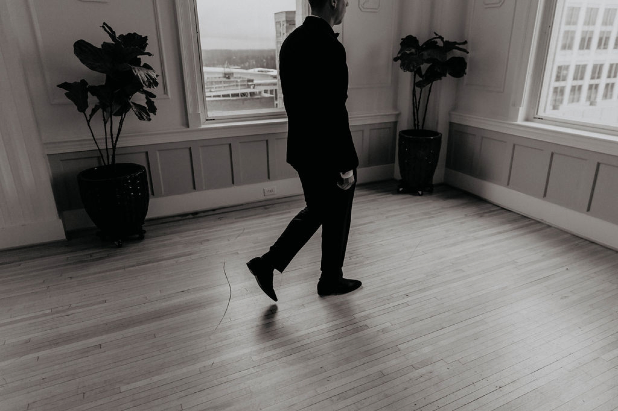 Groom walking into the cannon room - Matt Smarsh and Johanna Dye - suites by the black tux - Raleigh North Carolina Urban Edgy Downtown Wedding - suits by the black tux