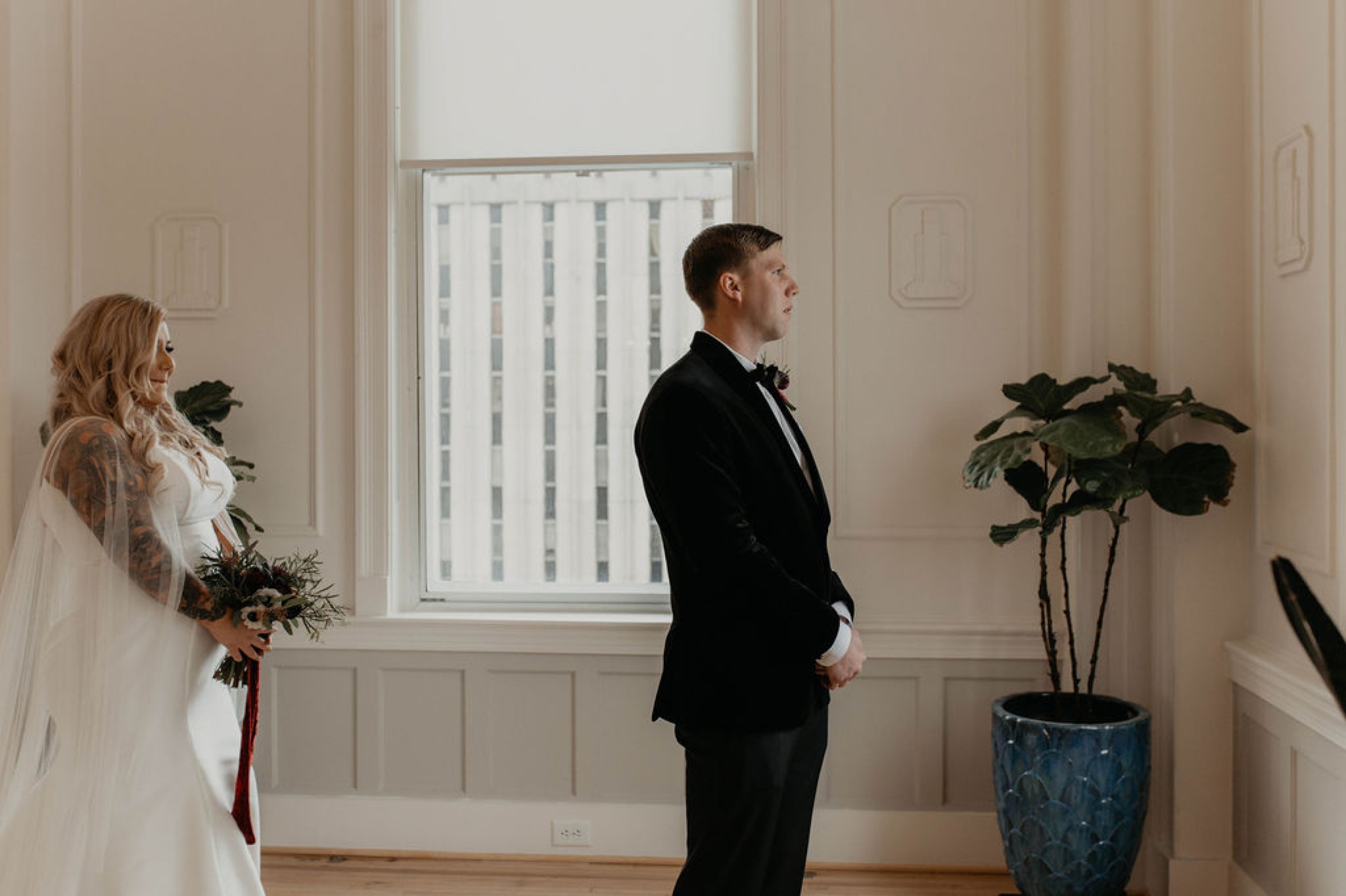 First look between bride and groom at the cannon room - Bride in an Allure Bridals Mermaid Gown - Matt Smarsh and Johanna Dye - suites by the black tux - Raleigh North Carolina Urban Edgy Downtown Wedding - suits by the black tux