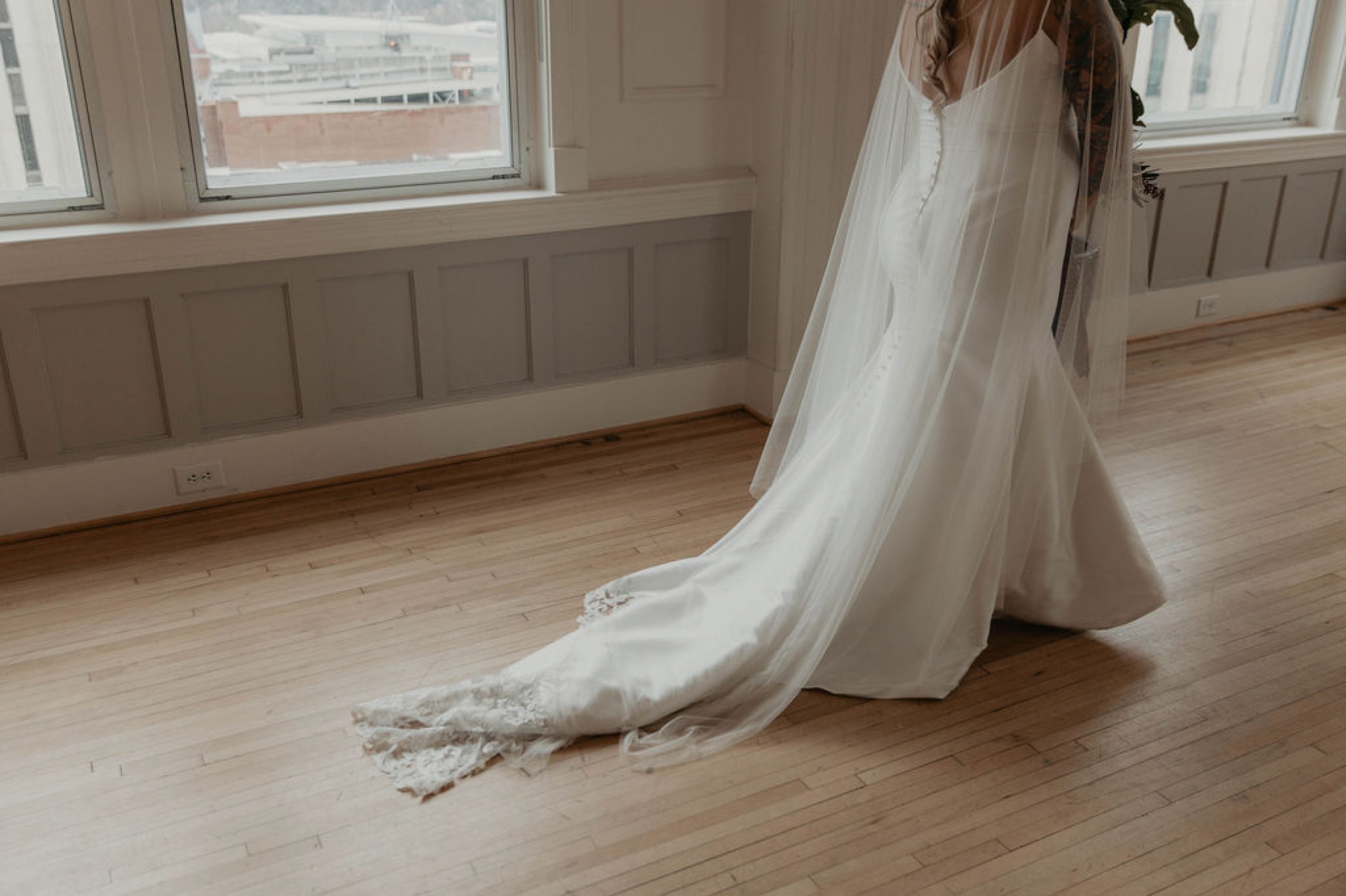 The cannon room - Bride walking in an Allure Bridals Mermaid Gown - Matt Smarsh and Johanna Dye - suites by the black tux - Raleigh North Carolina Urban Edgy Downtown Wedding - suits by the black tux