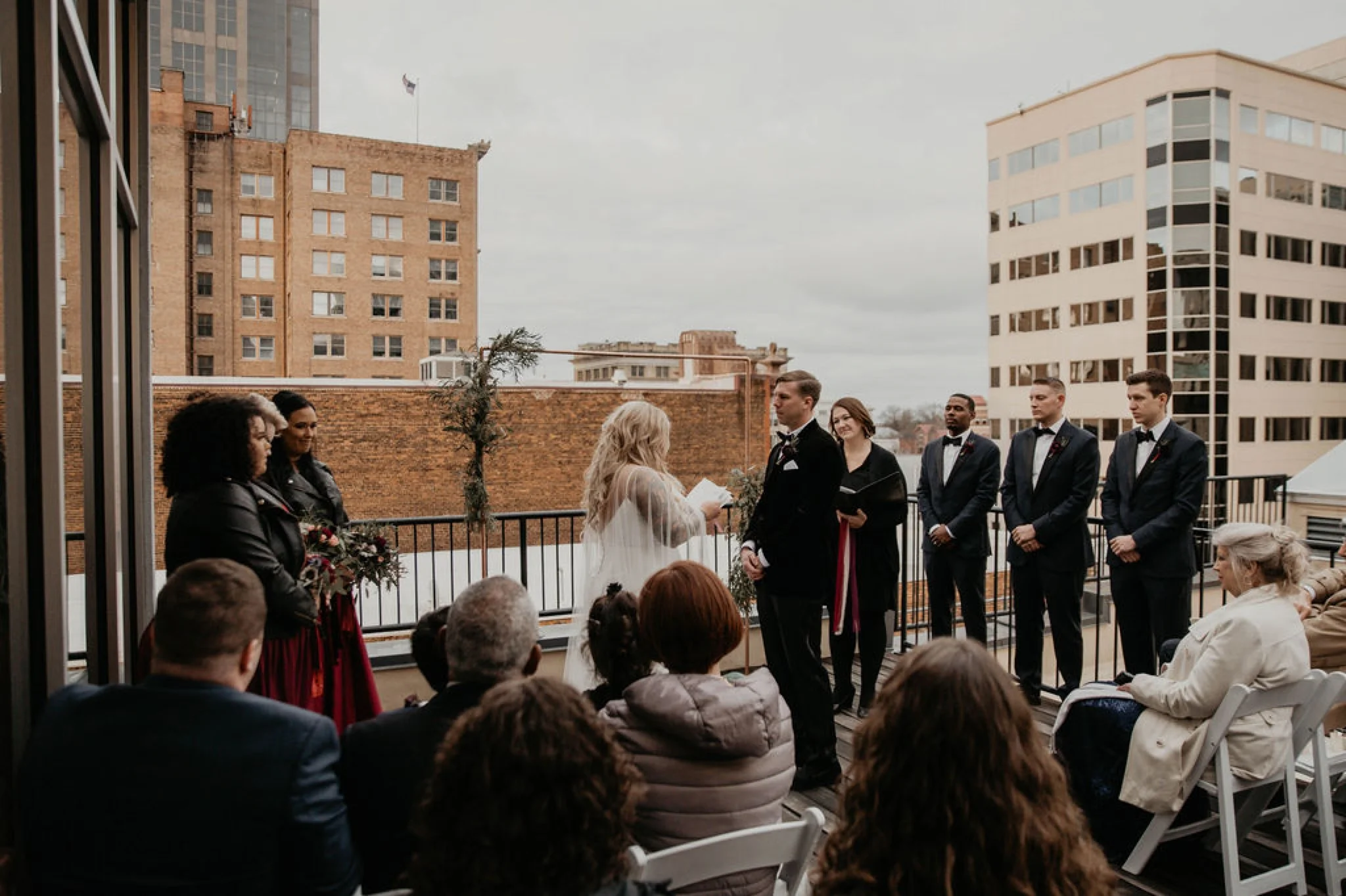 Bride reading her vows - Wedding Ceremony on a rooftop terrace with the skyline in the background - Matt Smarsh and Johanna Dye - Raleigh North Carolina Urban Downtown Wedding at the Glass Box at 230
