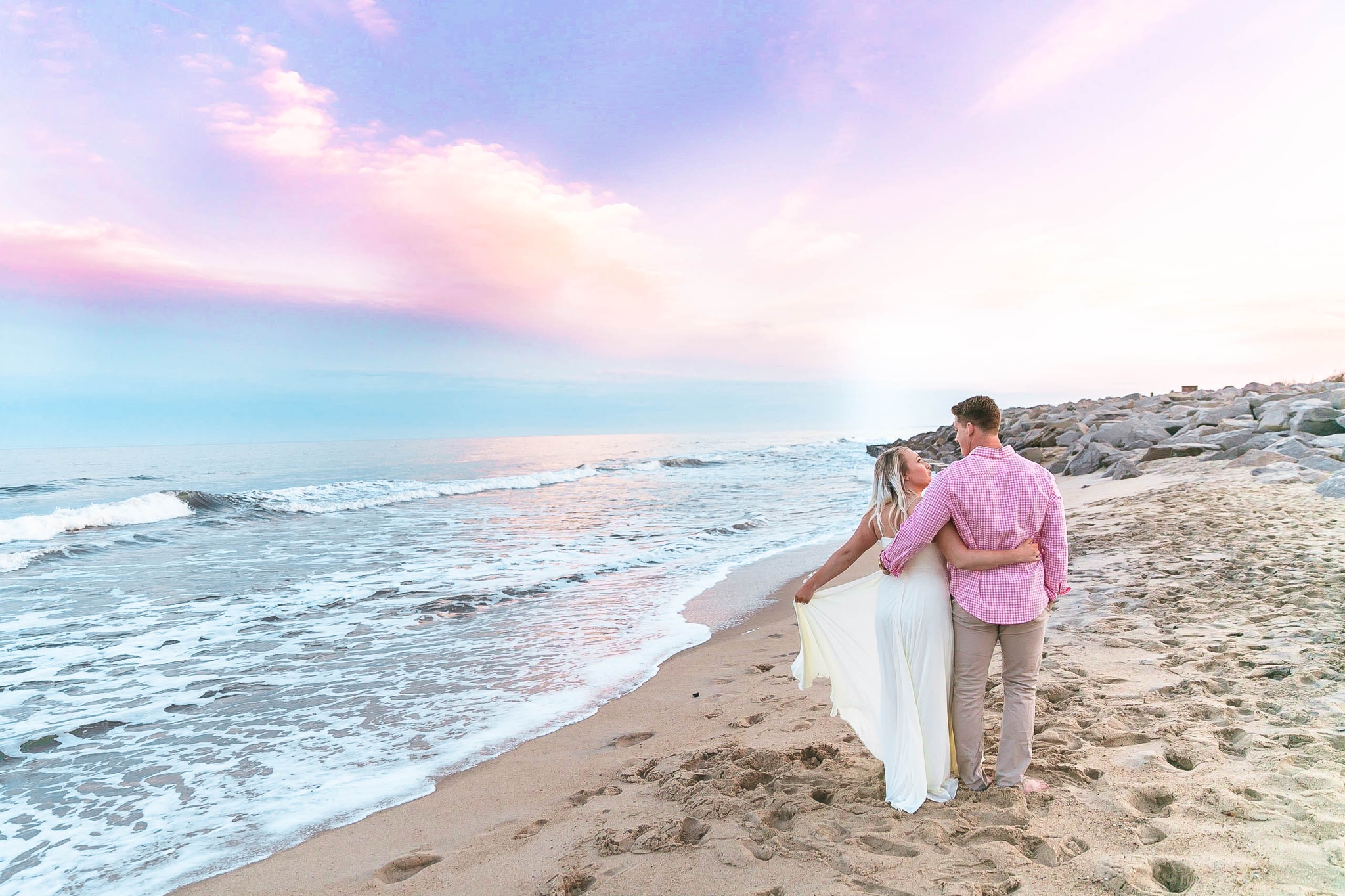  Romantic Engagement Photography Session at the beach during sunset with a cotton candy sky - guy is kissing his fiance - girl is wearing a white flowy maxi dress from lulus - Honolulu Oahu Hawaii Wedding Photographer - Johanna Dye 