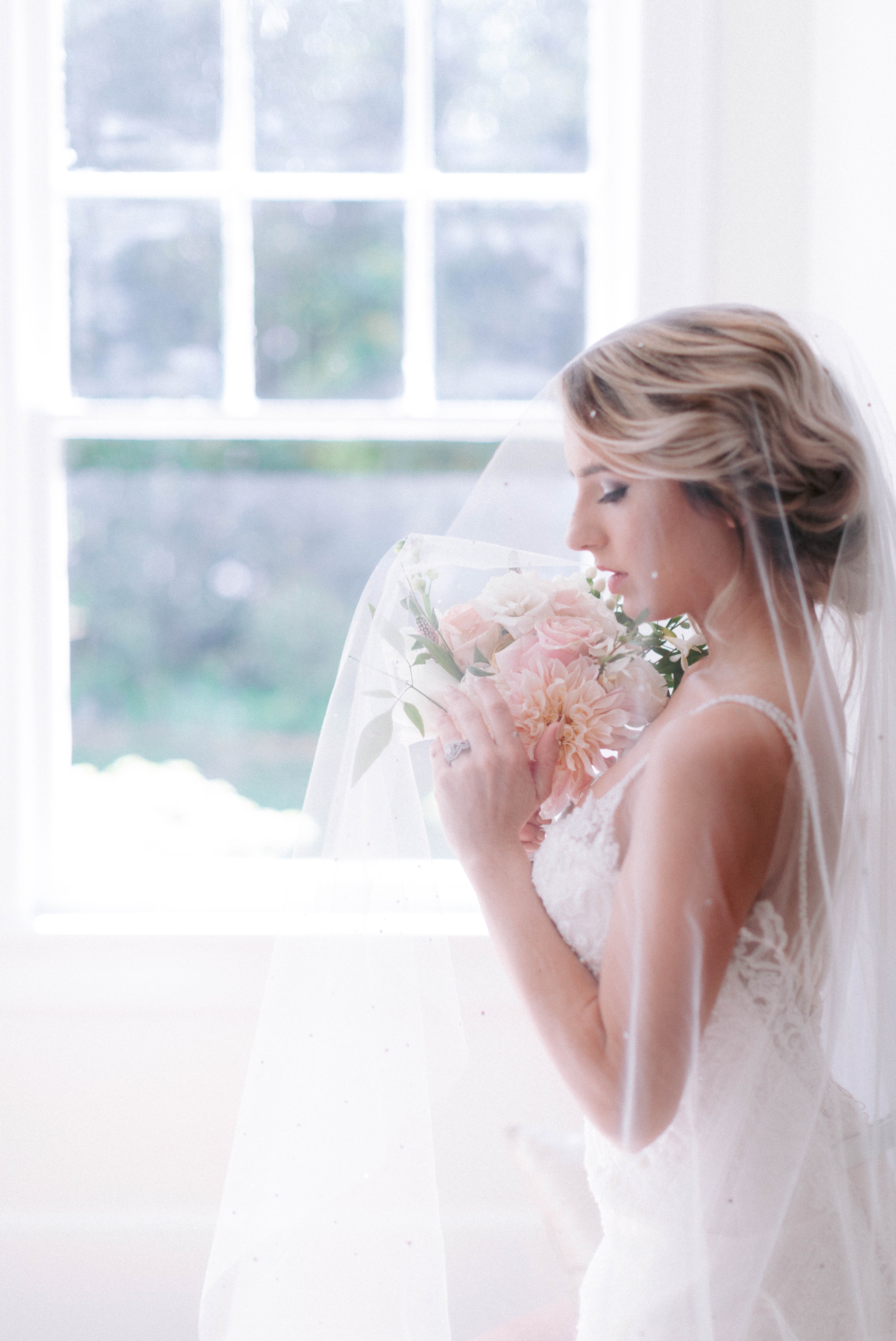  Indoor Natural Light Bridal Portraits by a window with a white backdrop - classic bride with pastel colors - wedding gown by Stella York - Honolulu, Oahu, Hawaii Wedding Photographer 