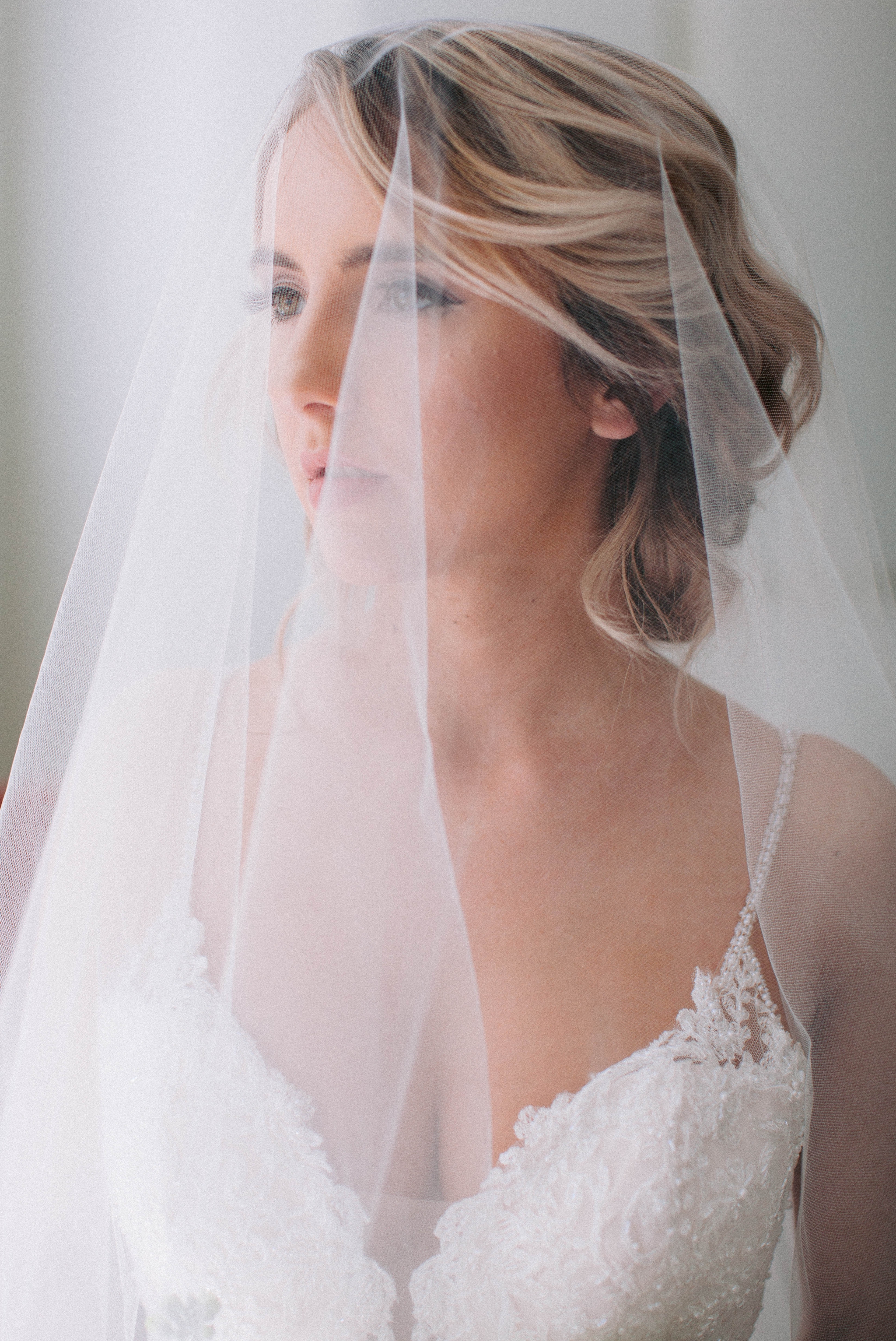  Indoor Natural Light Bridal Portraits by a window with a white backdrop - classic bride with soft drop veil over her face - wedding gown by Stella York - Honolulu, Oahu, Hawaii Wedding Photographer 