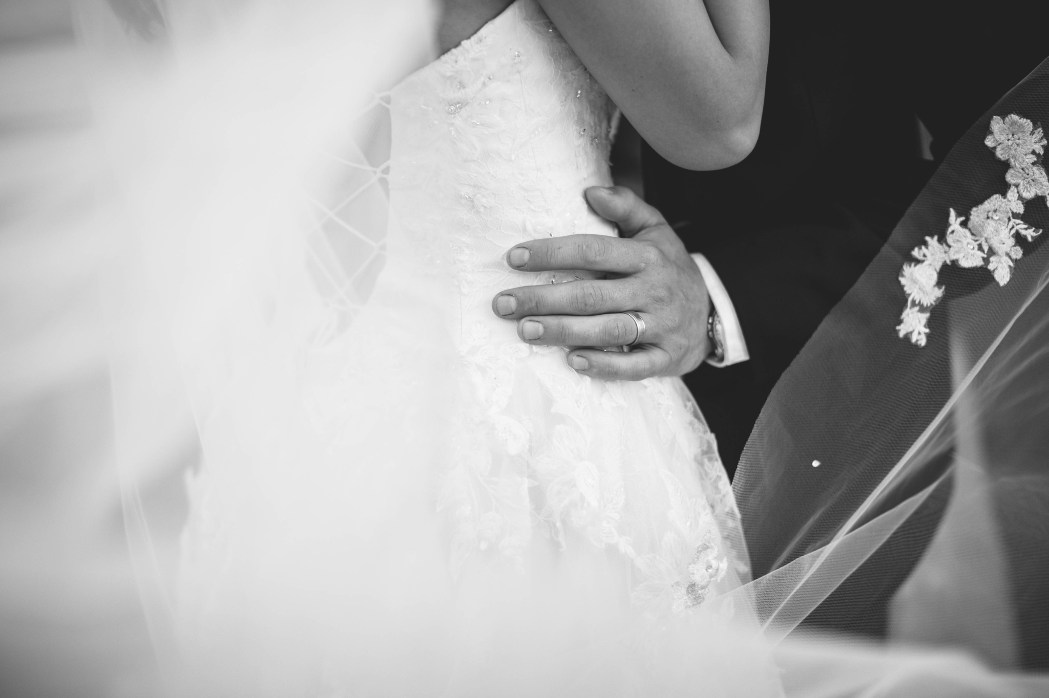  Black and white Veil shot - Wedding Portraits on the front porch of an all white luxury estate - Bride is wearing a Aline Ballgown by Cherish by Southern Bride with a long cathedral veil - Groom is wearing a black suit by Generation Tux and has a ma