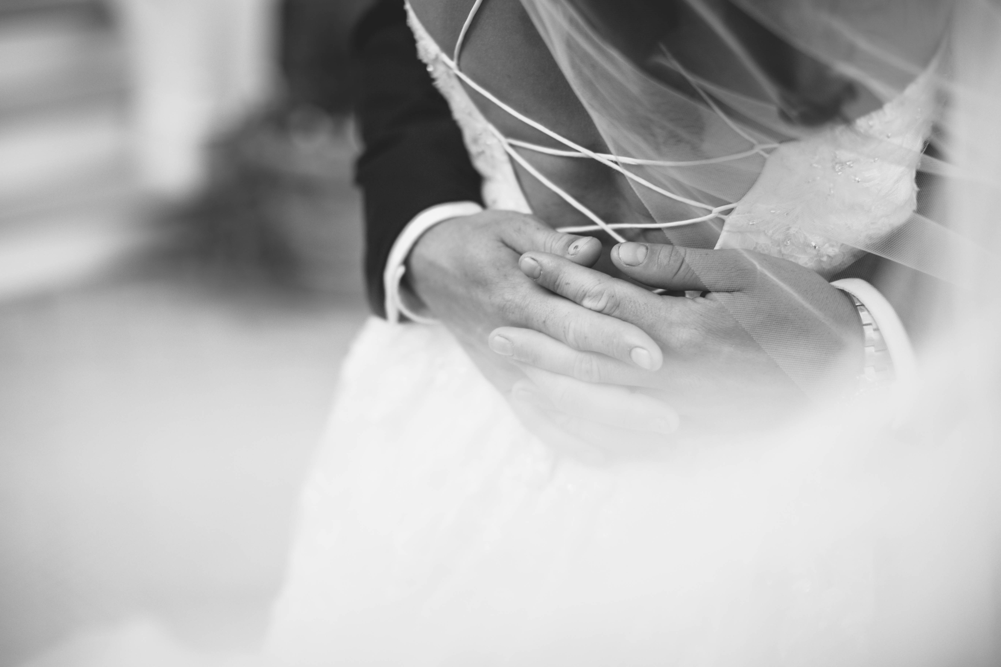  Veil shot - Wedding Portraits on the front porch of an all white luxury estate - Bride is wearing a Aline Ballgown by Cherish by Southern Bride with a long cathedral veil - Groom is wearing a black suit by Generation Tux and has a man bun - Fine Art