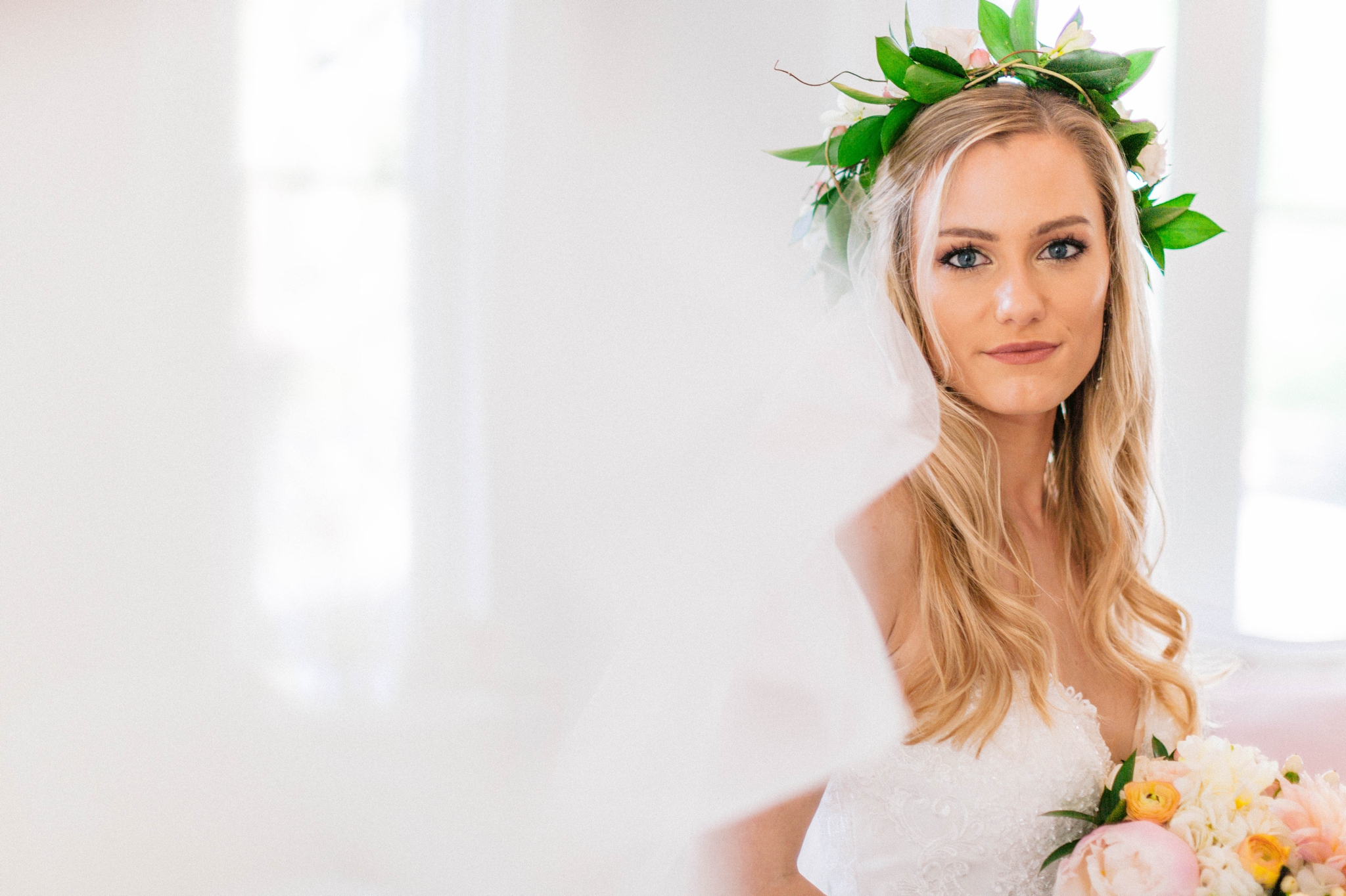  Veil shot - Indoor Bridal Portraits in an all white room at a luxury estate with natural light before the ceremony - Bride is wearing a Hawaiian Flower Crown and a cathedral veil in a Wedding Gown by Stella York and standing in the doorway with a go