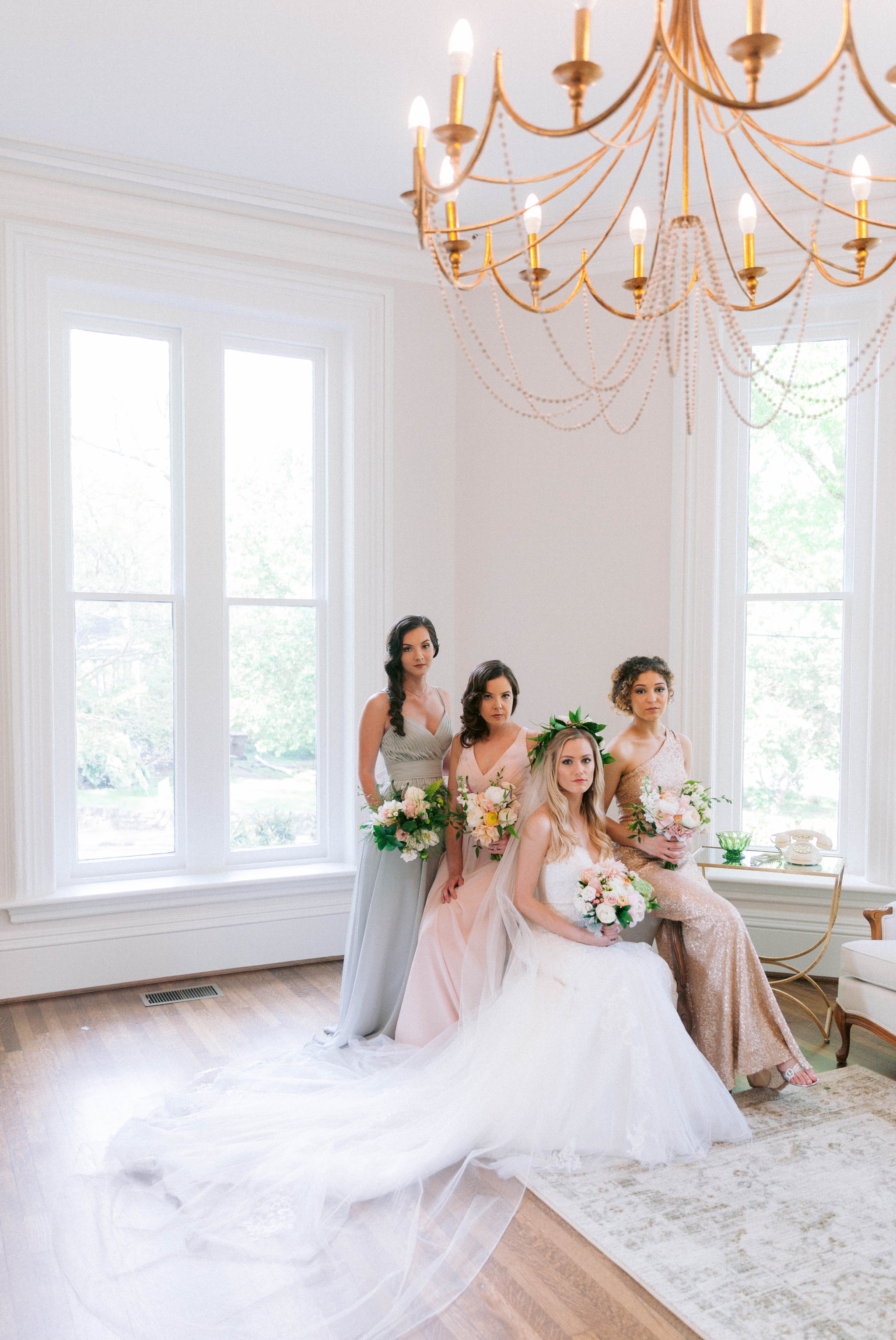  Indoor Bride + bridesmaids portraits in an all white room at a luxury estate with natural light before the ceremony - Bride is wearing a Hawaiian Flower Crown and a cathedral veil in a Wedding Gown by Stella York -  Honolulu Oahu Hawaii Fine Art Wed