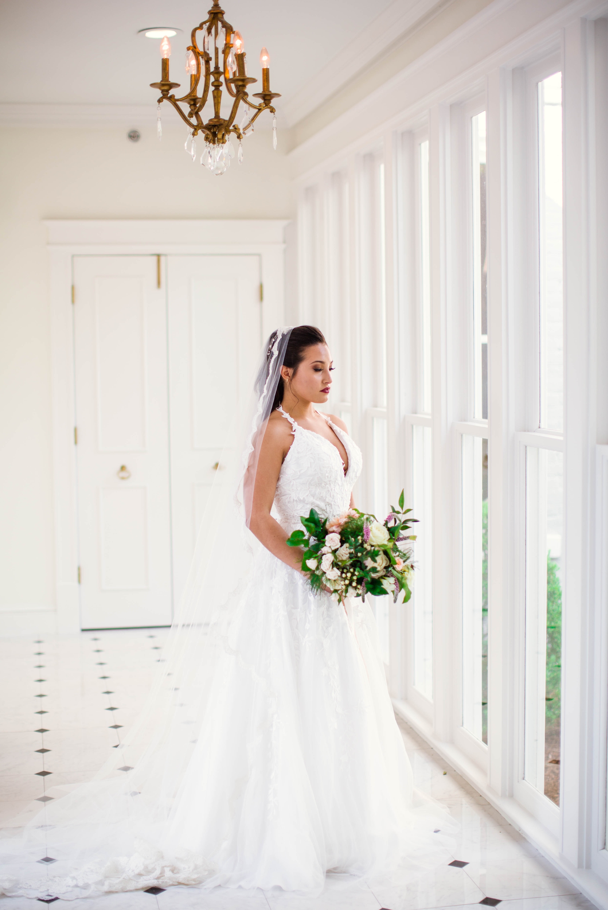  Natural light Bridal Portraits in an all white luxury estate venue with black and white floors and a golden chandelier - Bride is wearing a Wedding Dress by Sherri Hill - shot with available window light - Fine Art Wedding Photographer in Honolulu O