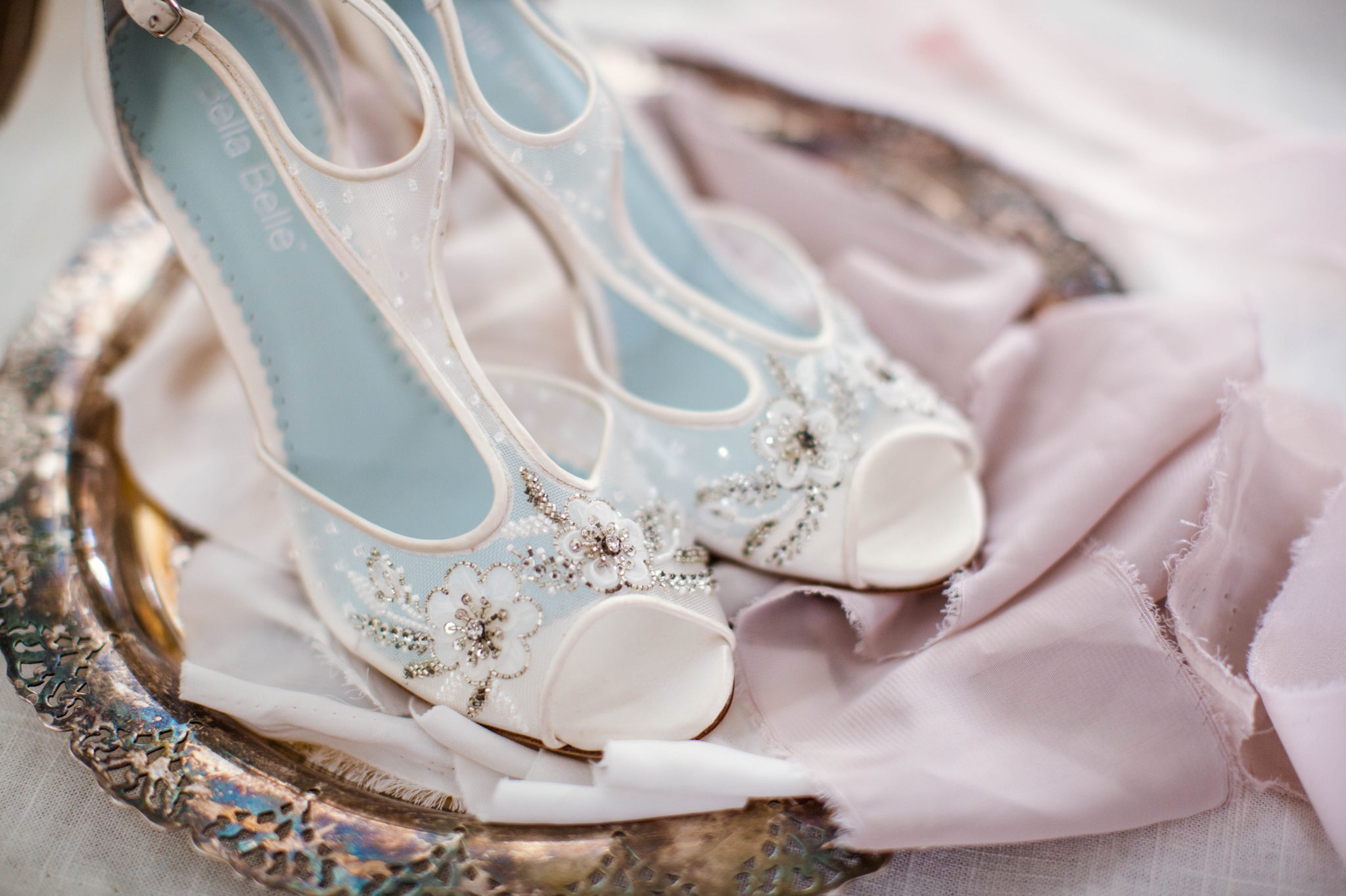  detail shot of all white bridal shoes with light blue details on an antique tray - Fine Art Wedding Photographer in Honolulu, Oahu, Hawaii - edited with the for the love of film presets by jose villa 