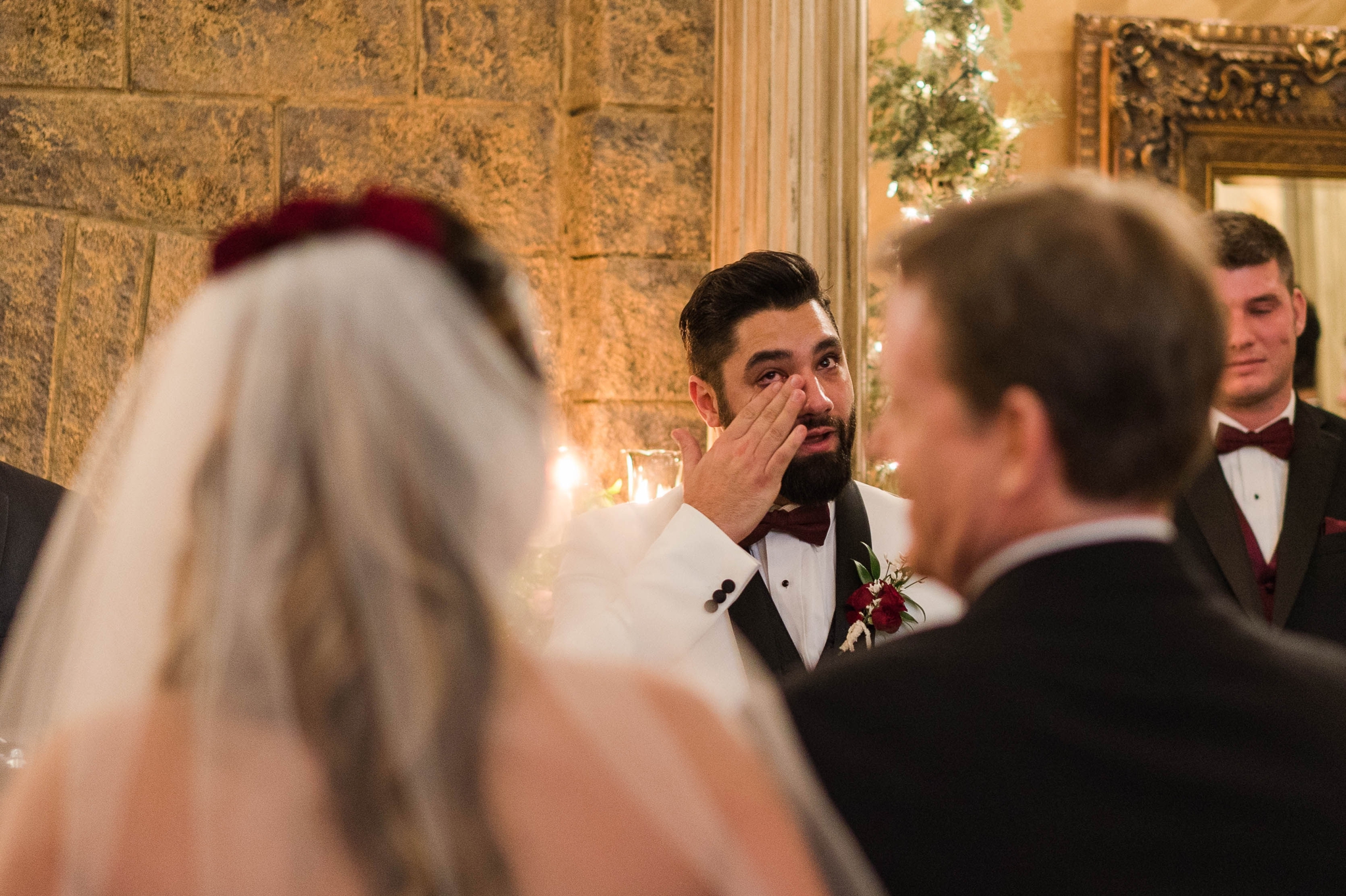 Groom wiping the tears from his face as he sees his bride standing in front of him at the altar - Honolulu Oahu Hawaii Wedding Photographer