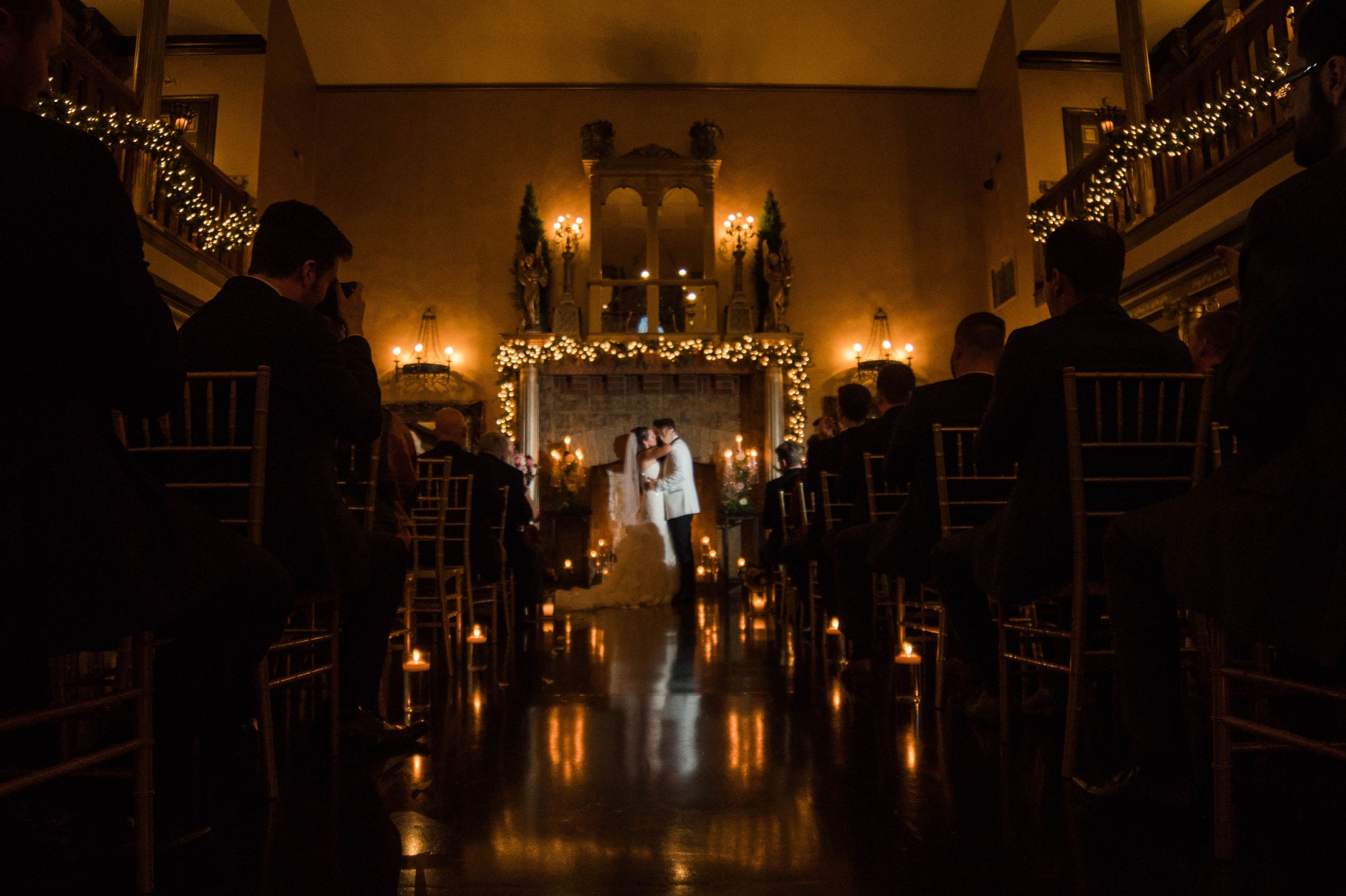 First kiss in a castle lit by candles during the wedding ceremony - Honolulu Oahu Hawaii Wedding Photographer