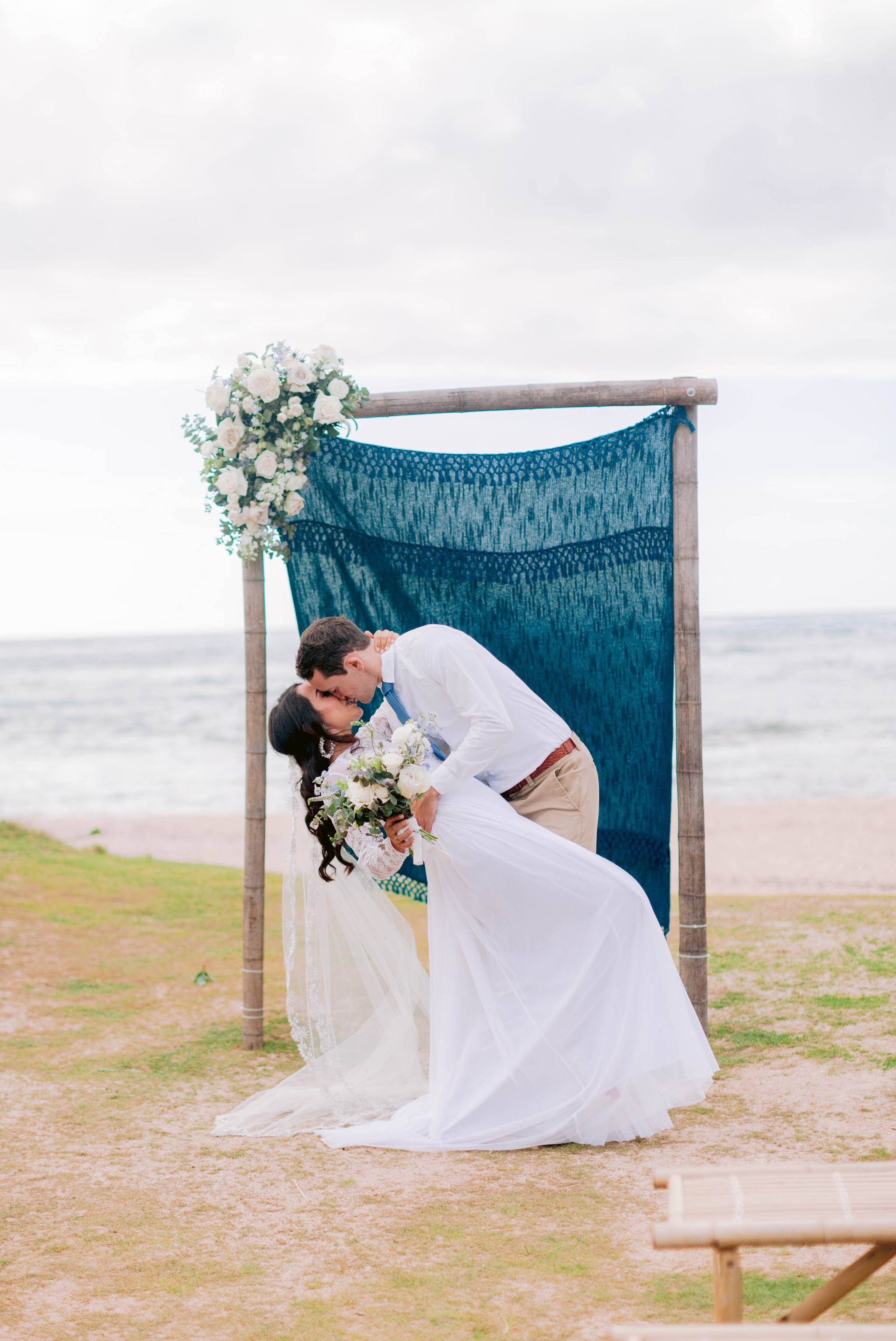 The first kiss between bride and broom at the ceremony Ana + Elijah - Wedding at Loulu Palm in Haleiwa, HI - Oahu Hawaii Wedding Photographer 