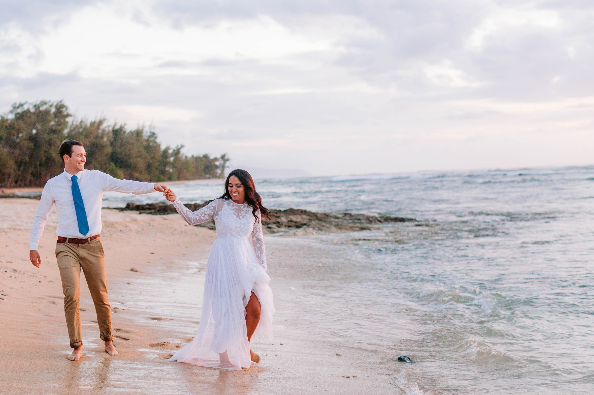  Bride and Groom walking on the beach - Wedding Portraits at Sunset in Hawaii - Ana + Elijah - Wedding at Loulu Palm in Haleiwa, HI - Oahu Hawaii Wedding Photographer - #hawaiiweddingphotographer #oahuweddings #hawaiiweddings 