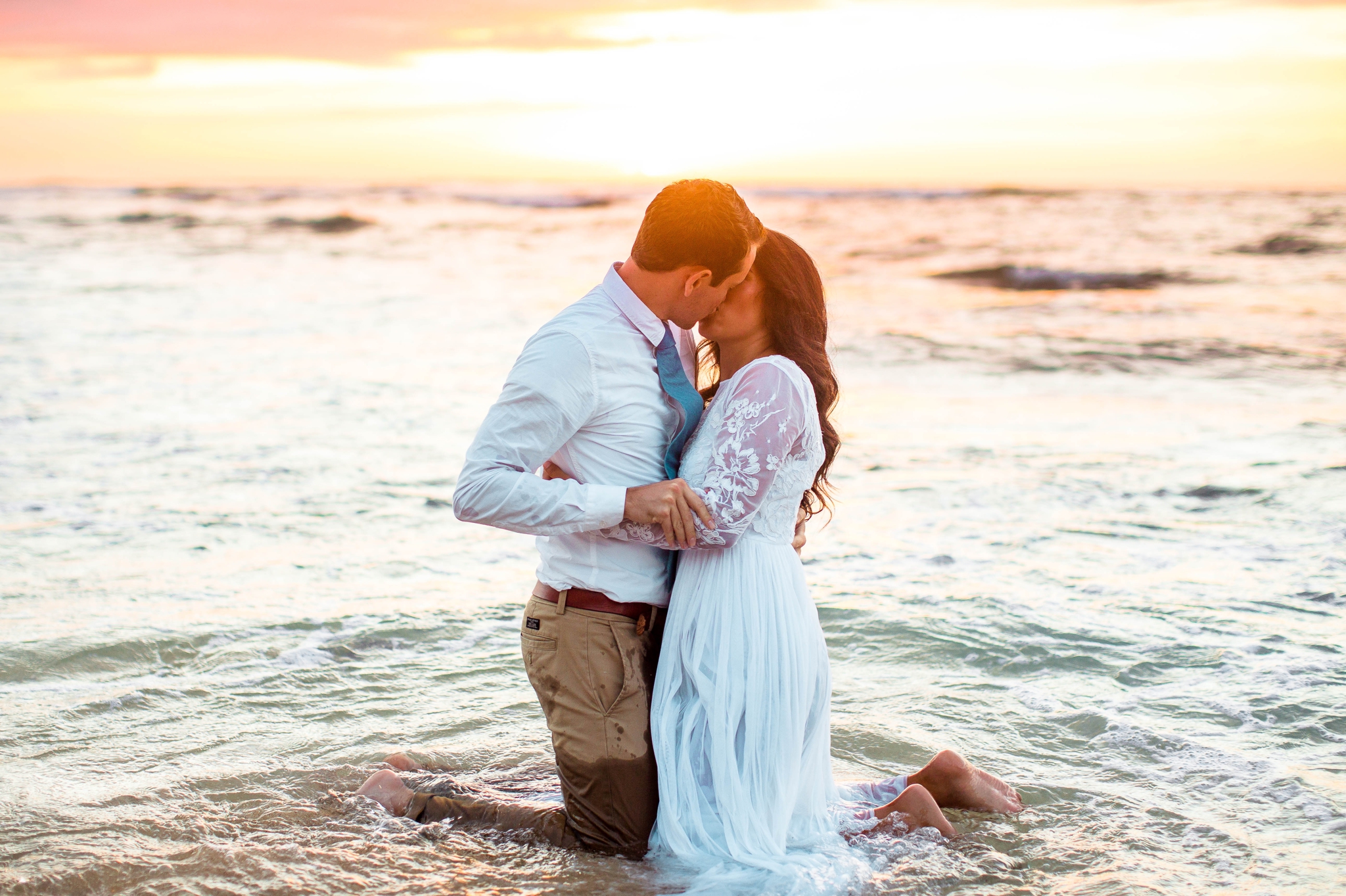  Bride and Groom kissing in the ocean - Wedding Portraits at Sunset in Hawaii - Ana + Elijah - Wedding at Loulu Palm in Haleiwa, HI - Oahu Hawaii Wedding Photographer - #hawaiiweddingphotographer #oahuweddings #hawaiiweddings 