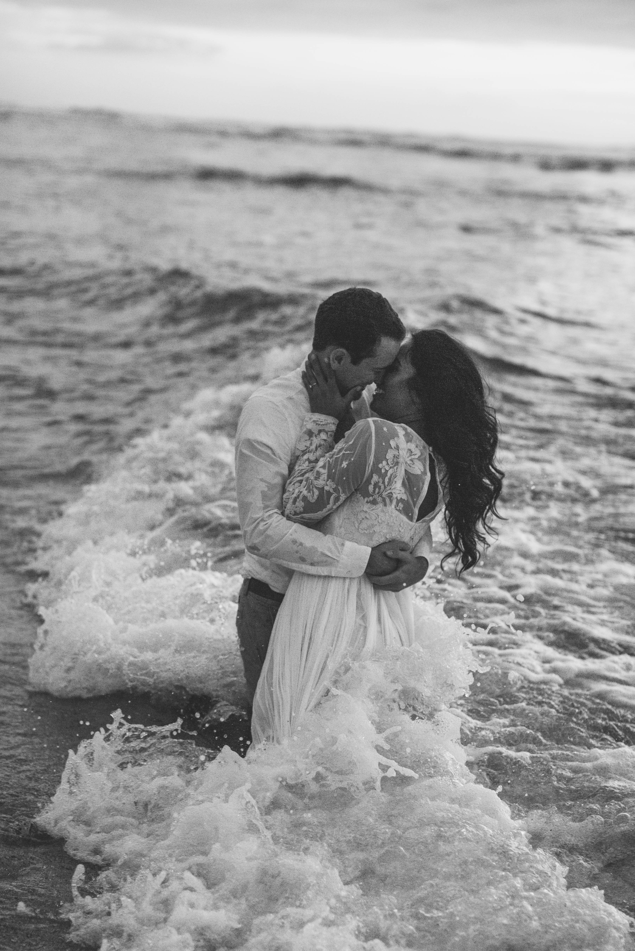  Bride and Groom in the ocean black and white - Wedding Portraits at Sunset in Hawaii - Ana + Elijah - Wedding at Loulu Palm in Haleiwa, HI - Oahu Hawaii Wedding Photographer - #hawaiiweddingphotographer #oahuweddings #hawaiiweddings 