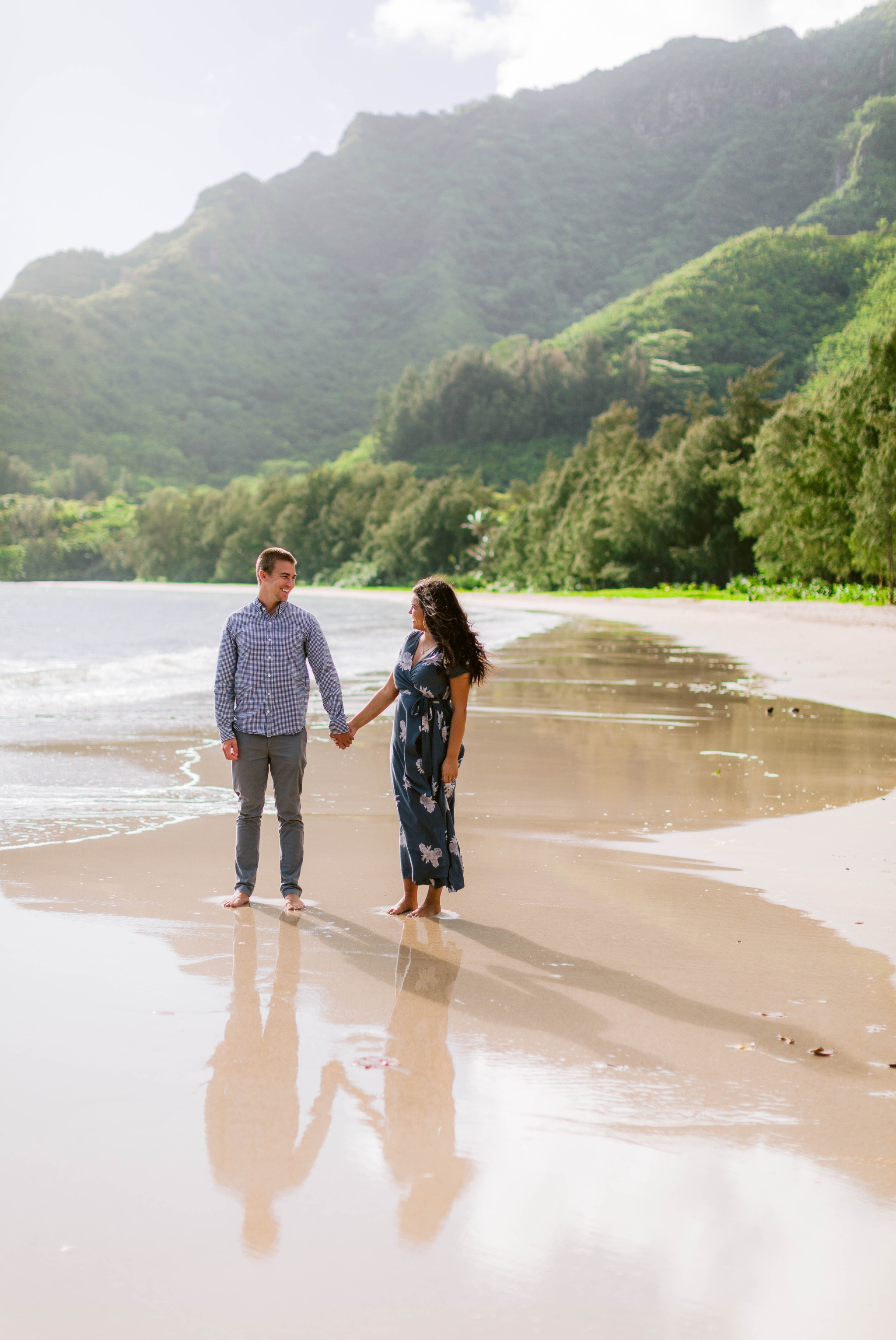  Couple at the shore with their reflections in the sand - Rilee + Max - Beach Engagement Session at Kahana Bay in Kaaawa, HI - Oahu Hawaii Wedding Photographer - #hawaiiengagementphotographer #oahuengagementphotographer 