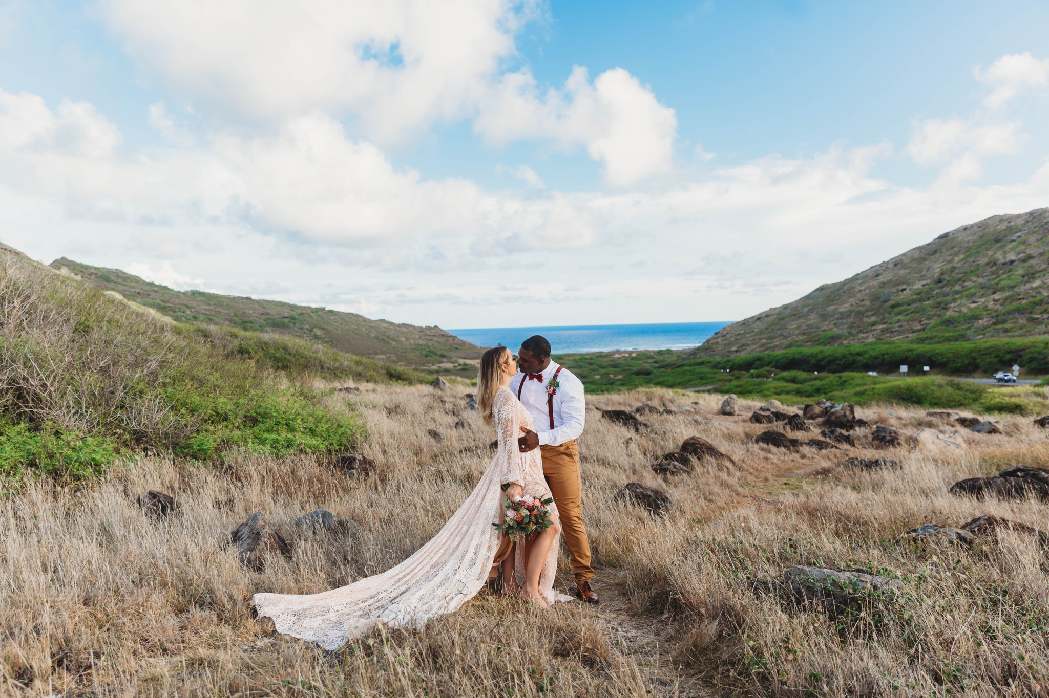  Elopement at Makapuu Lookout, Waimanalo, HI - Oahu Hawaii Engagement Photographer - Bride in a flowy fringe boho wedding dress - in grassy mountains with the ocean in the back - lanikai lookout - deutsche hochzeits fotografin in hawaii  