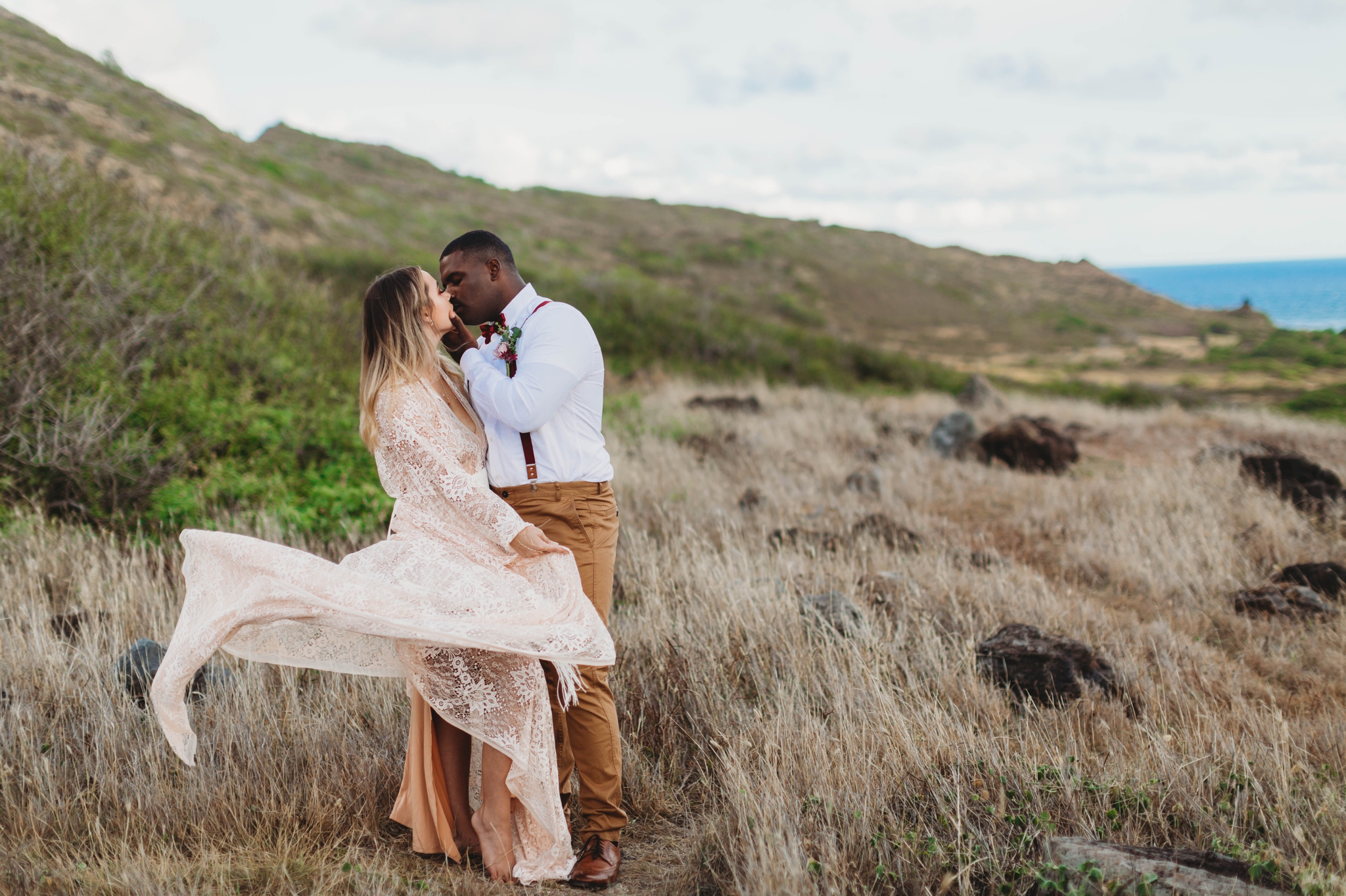  Elopement at Makapuu Lookout, Waimanalo, HI - Oahu Hawaii Engagement Photographer - Bride in a flowy fringe boho wedding dress - in grassy mountains with the ocean in the back - lanikai lookout - deutsche hochzeits fotografin in hawaii 