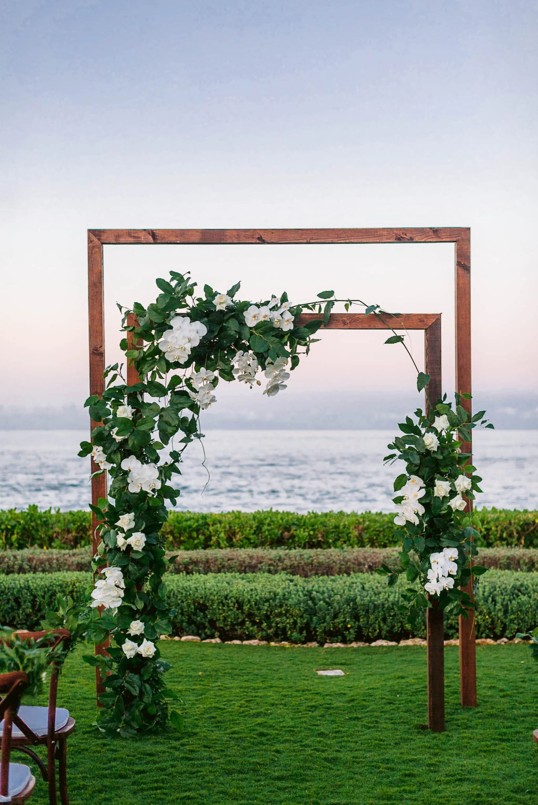 Ceremony set up with double arch decorated with white flowers by Aloha Artisians and Lulus Leis and BOuquets - Four Seasons Oahu at Ko Olina Wedding Inspiration  - Kapolei, Hawaii Photographer 