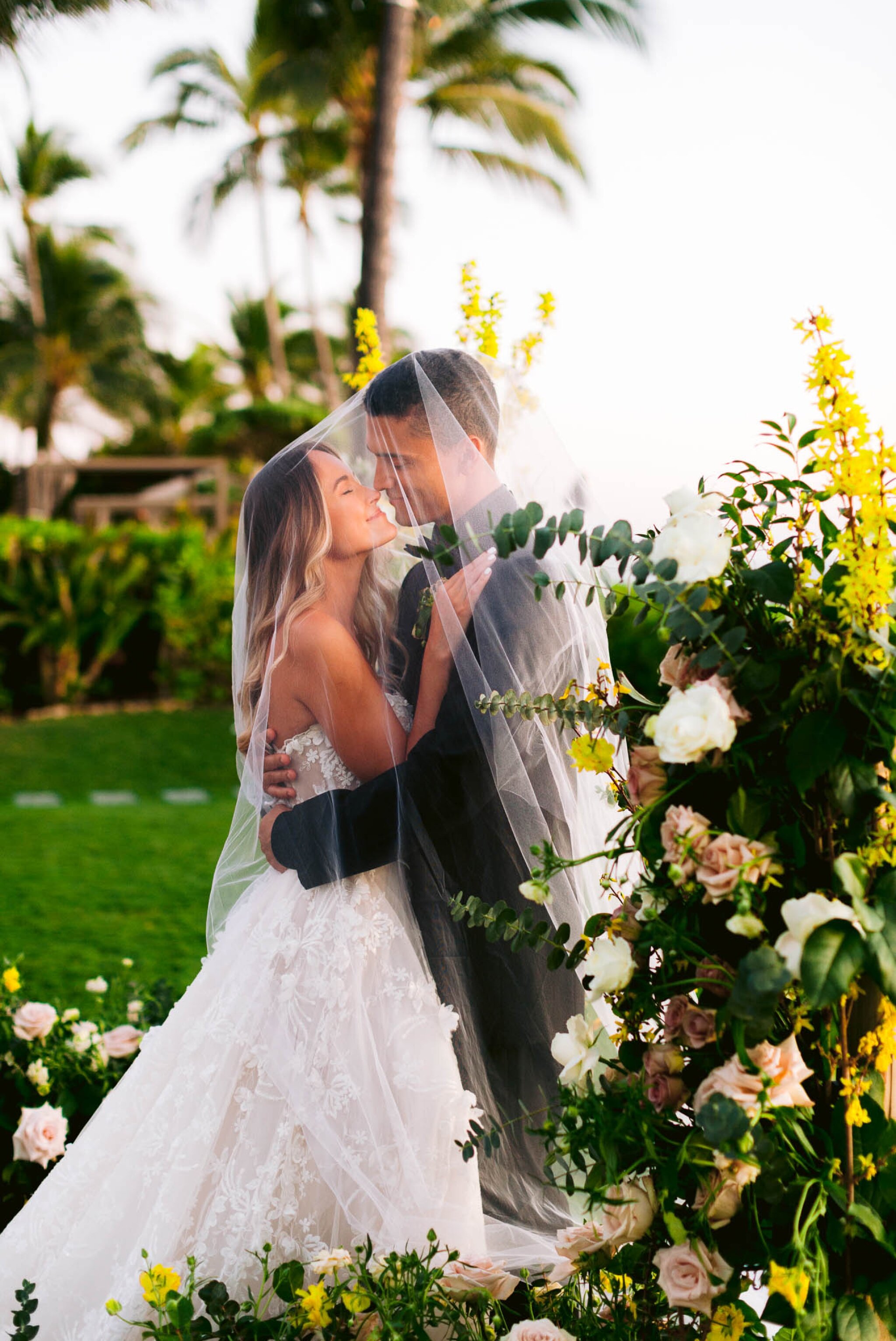 Bride and Groom at Sunset surrounded by flowers - - Four Seasons Oahu at Ko Olina Wedding Inspiration - Kapolei, Hawaii Photographer