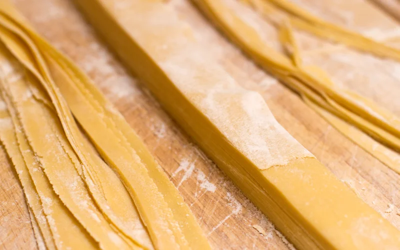 Stack neatly, cut off edges, and let dry. This is one looong strand of pasta!
