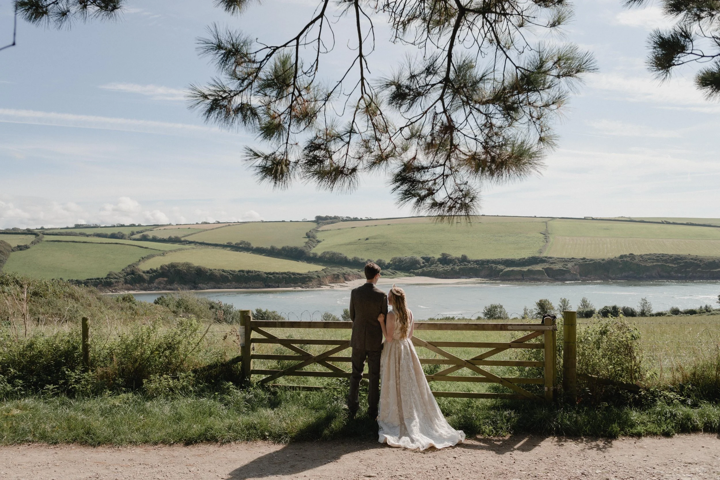 fairytale alternative wedding photography in Devon with scenes of bride and groom overlooking the estuary at Mothercombe bay
