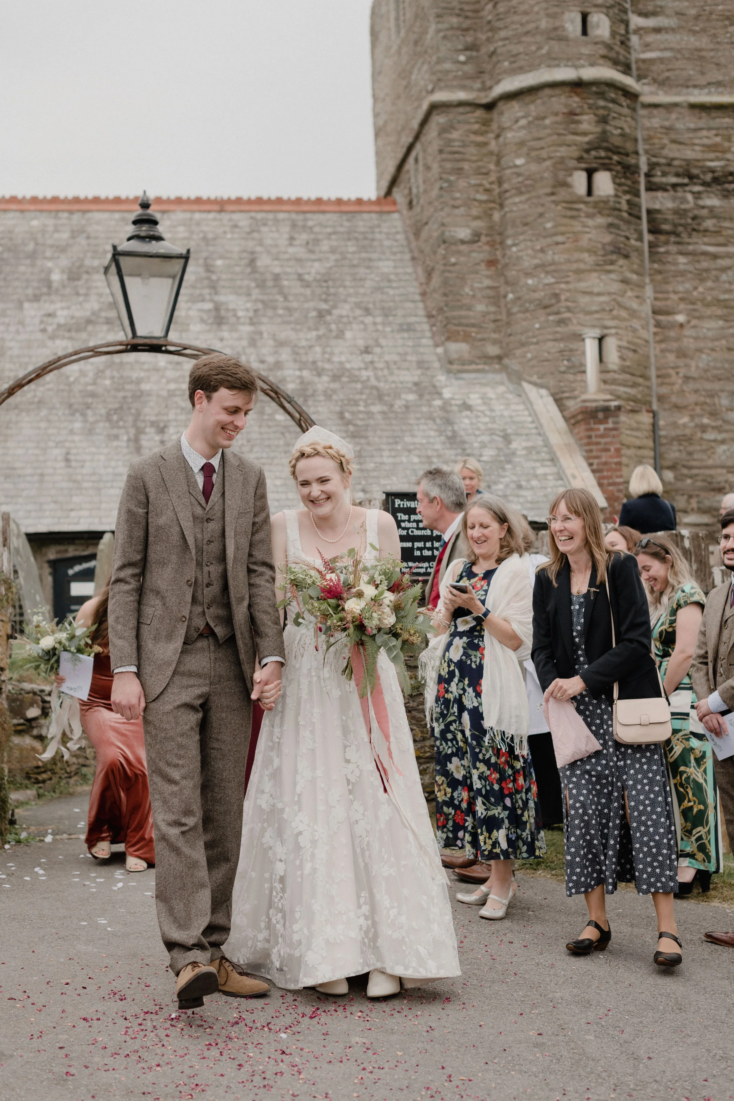 candid and fun wedding photography of bride and groom confetti moment