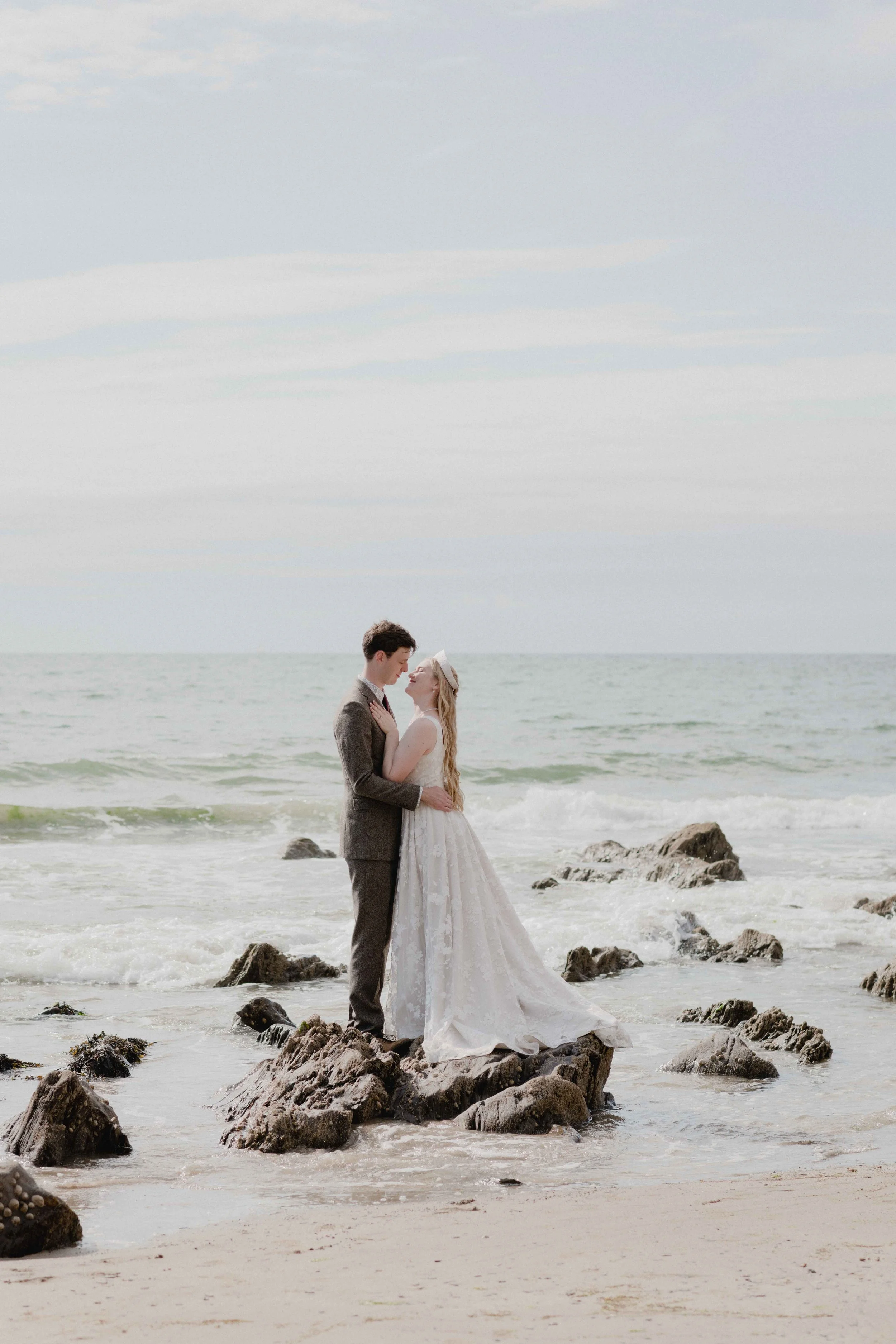 light and bright wedding photography of bride and groom by the seaside at mothercombe bay in Devon