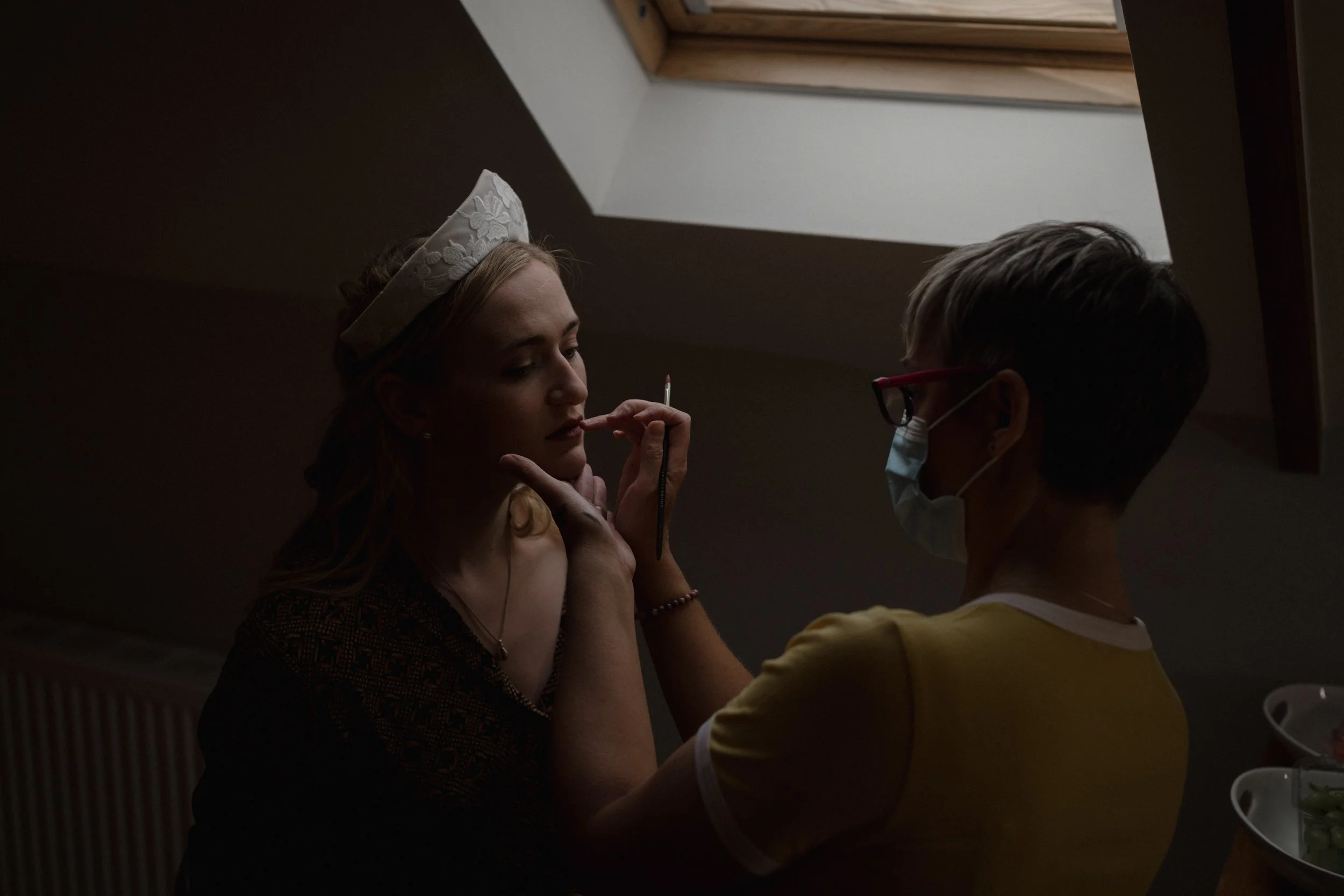 Claire Bowring Makeup artist in Devon doing Ishbel's makeup in the moody window light