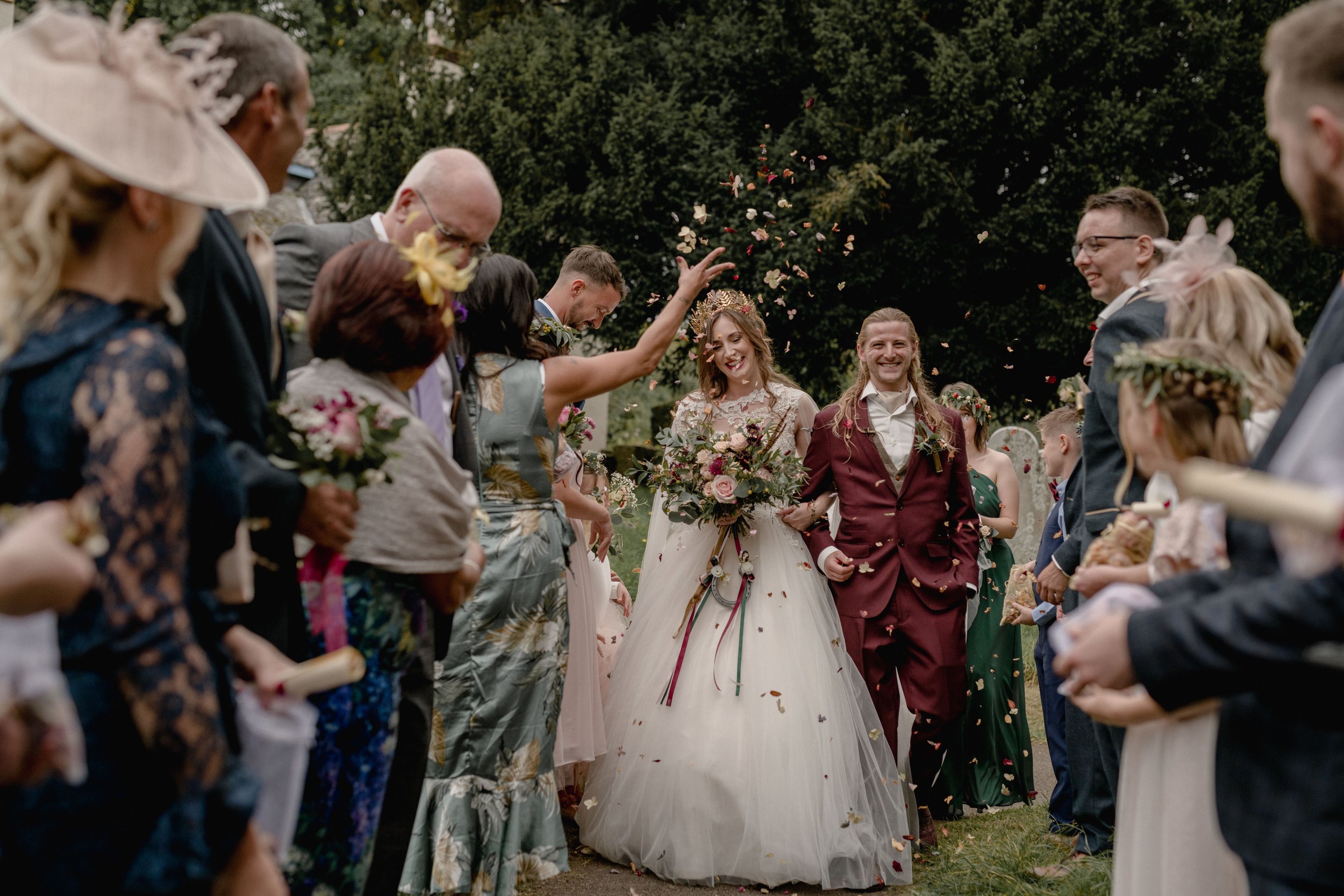 autumn wedding in devon with a fairytale bride and groom in a maroon suit captured by cornwall and devon wedding photographers and videographers