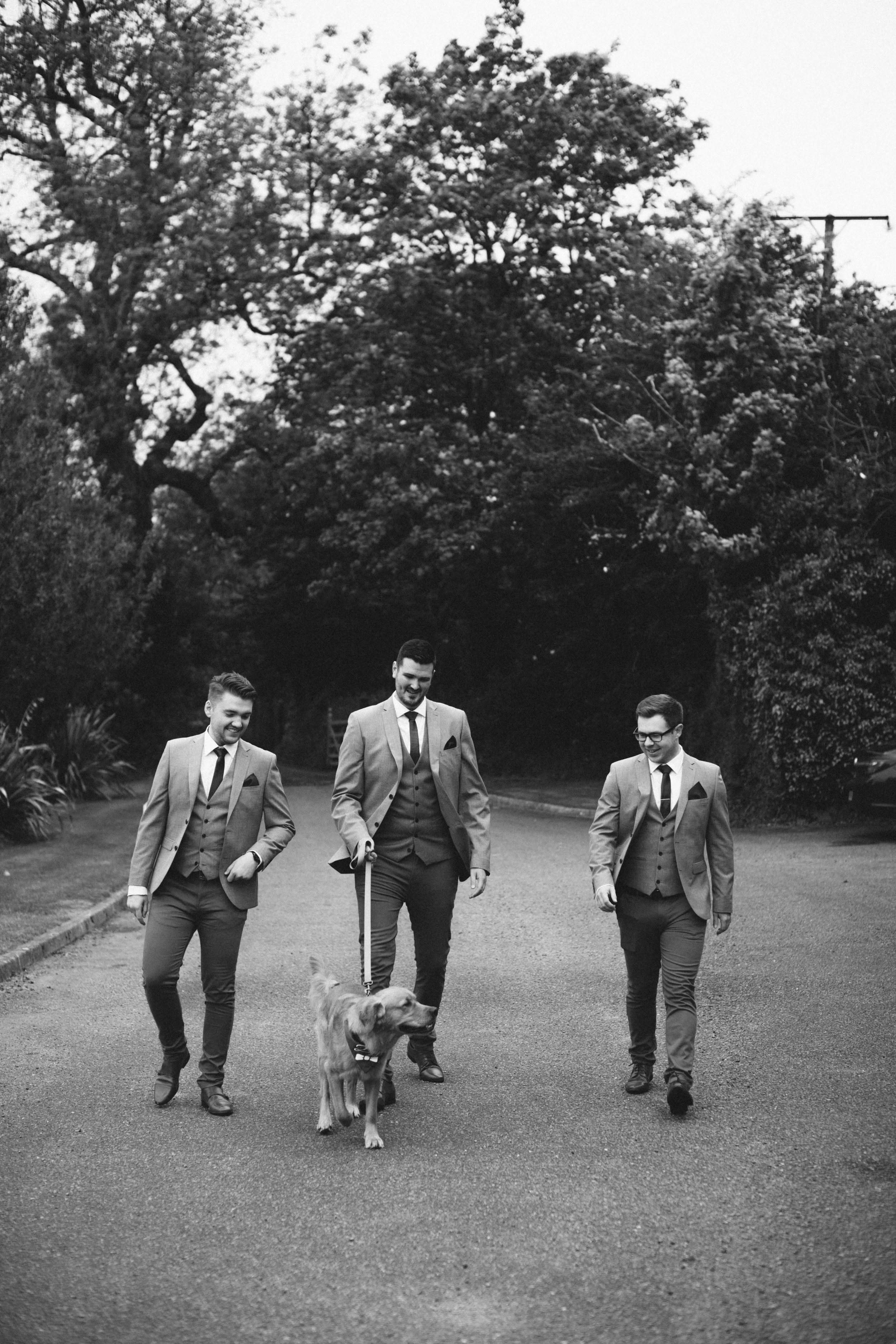 groomsmen with their dog at their dog friendly wedding venue in Cornwall Pengenna Manor