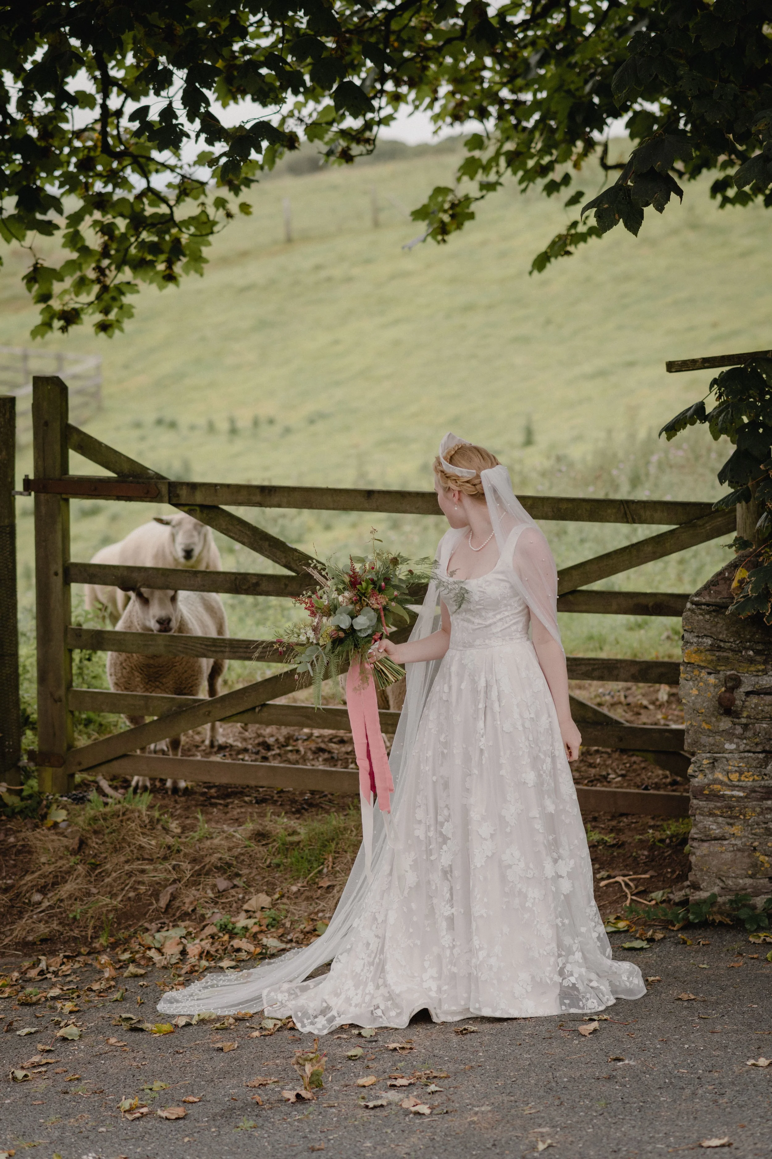 a sheep makes an appearance in this bridal portrait