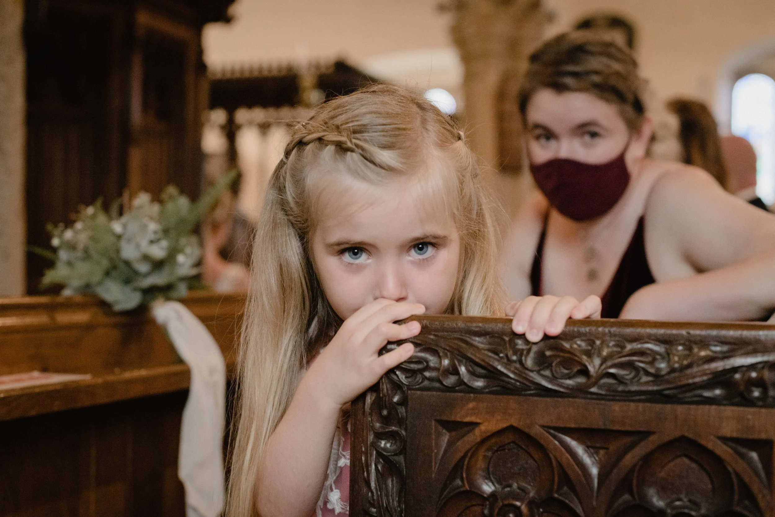 cheeky flowergirl candid photography moment in the church