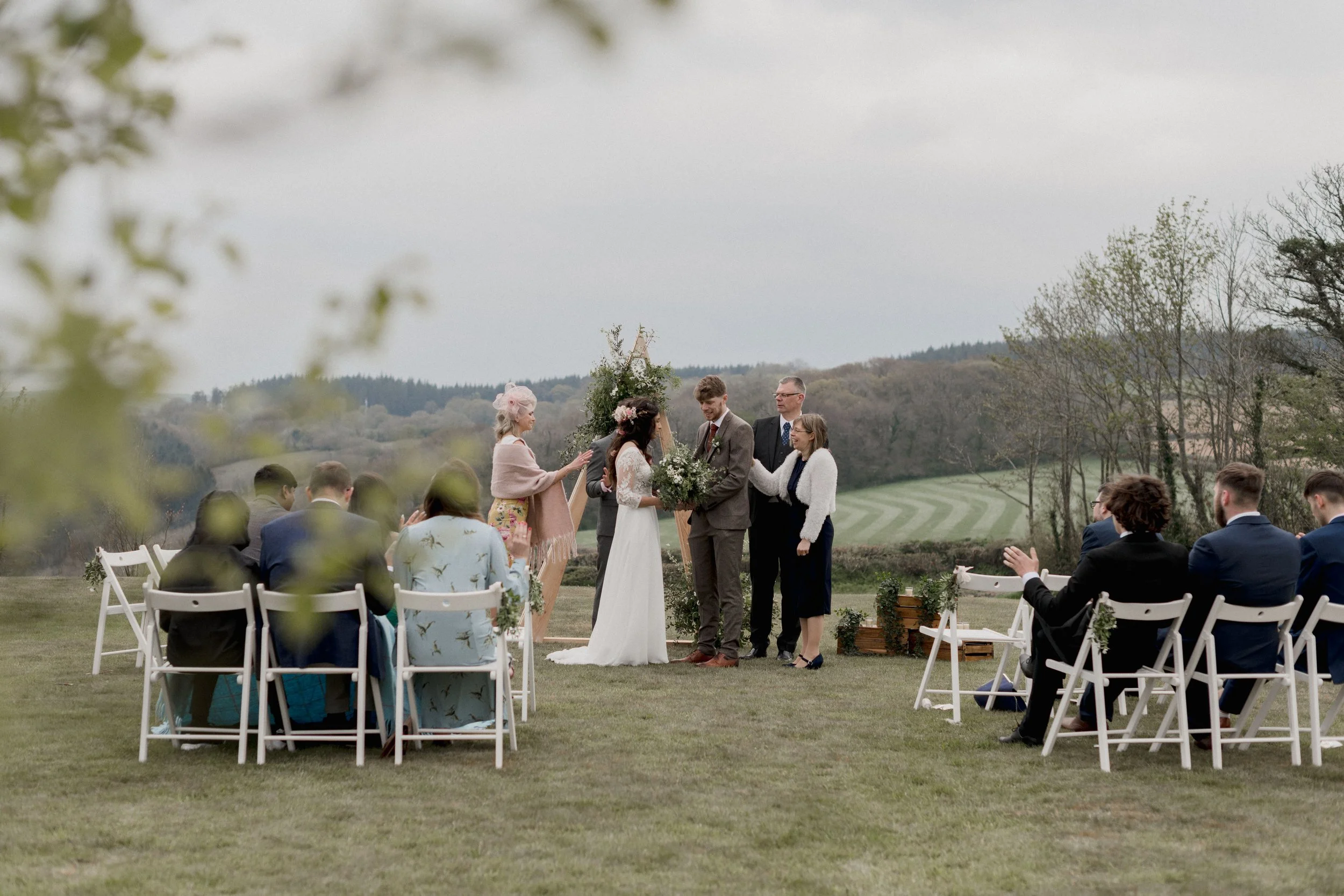 An outdoor christian wedding ceremony with greenery at Camel studio and intimate wedding venue in Cornwall