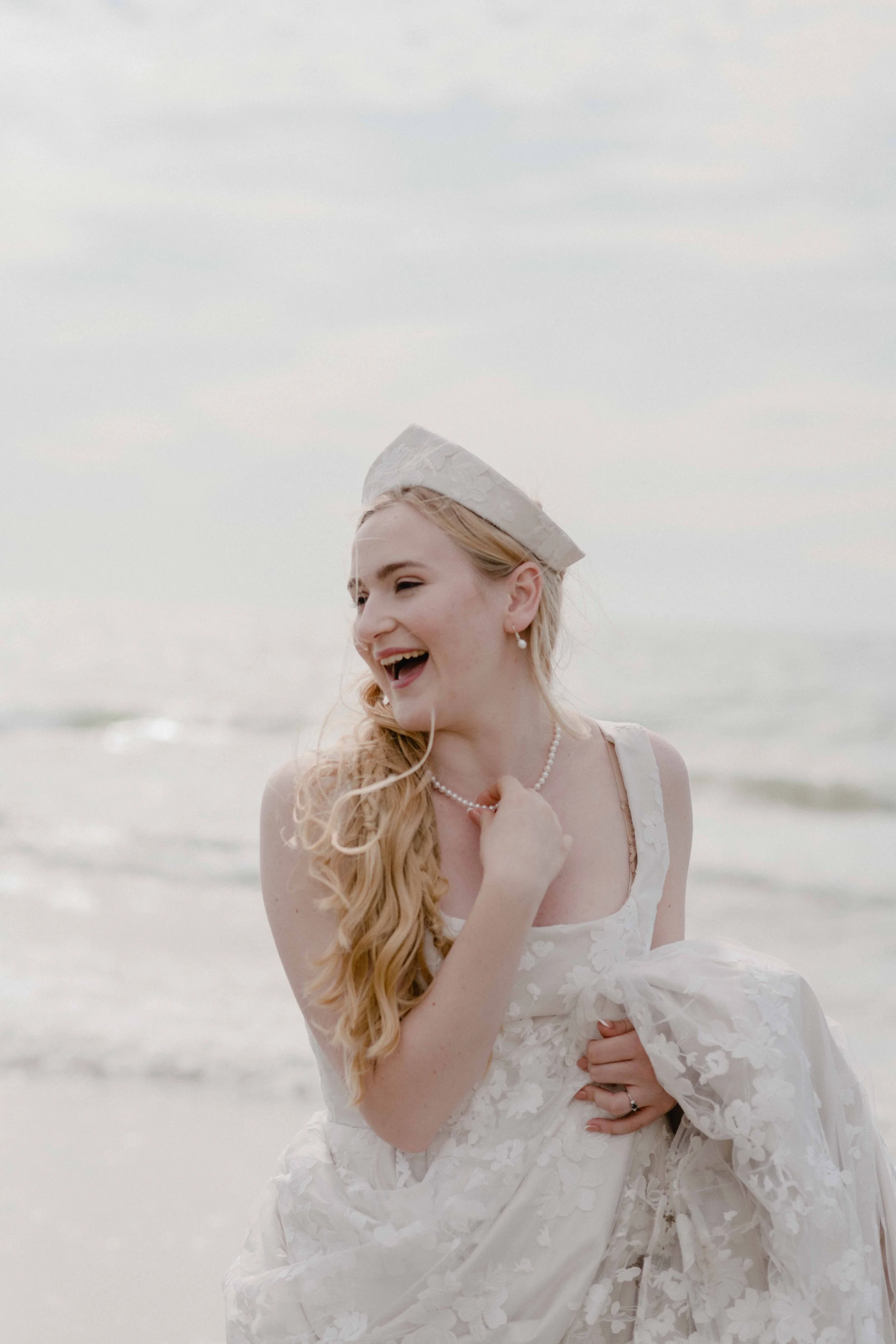bride in a blush Ailsa munro handmade wedding dress and kokoshnik by the seaside at her outdoor Devon wedding