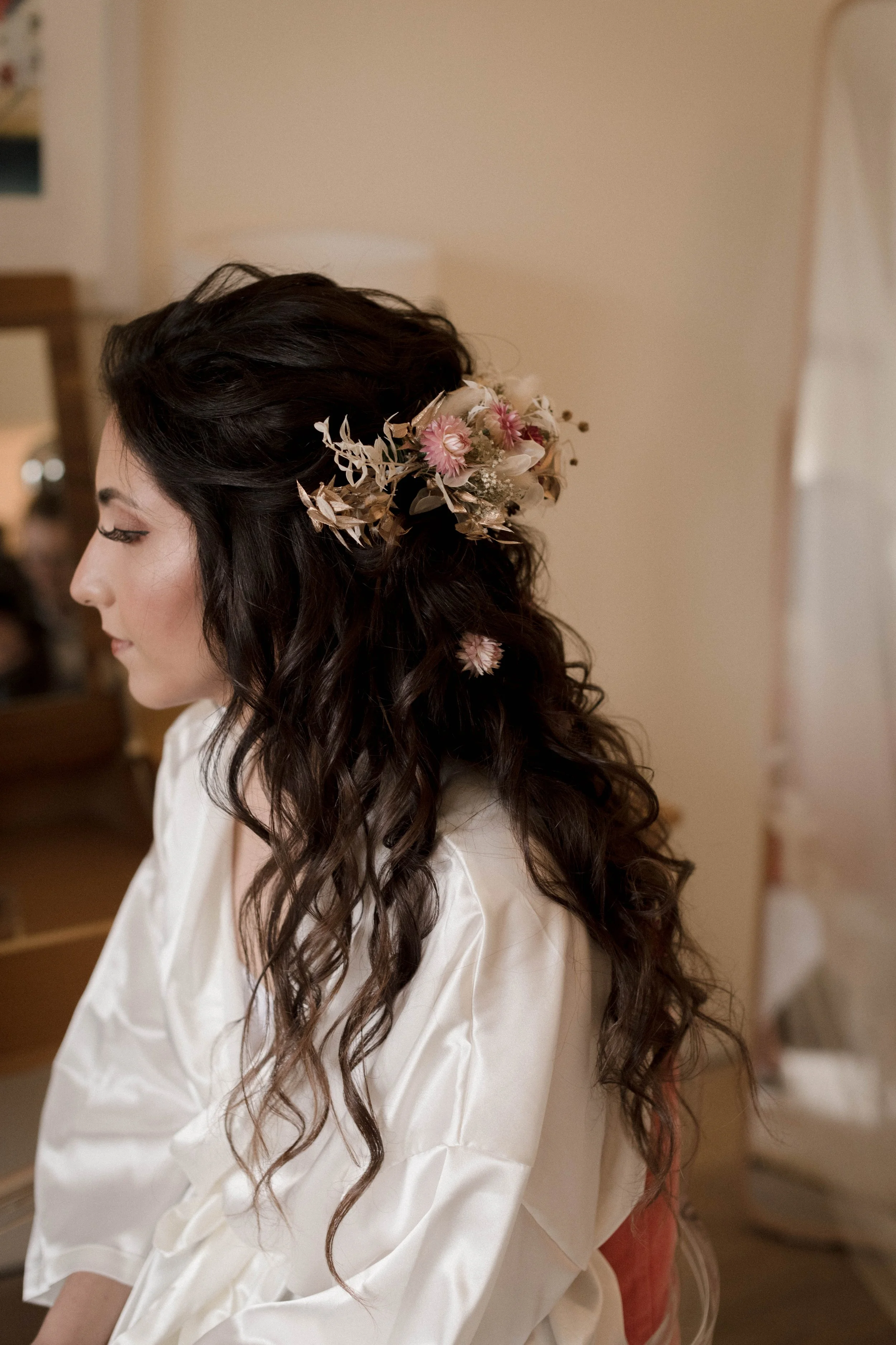 Cornwall bride with boho wedding hair and dried flowers with hair and makeup by Emilies hair and makeup Cornwall MUA
