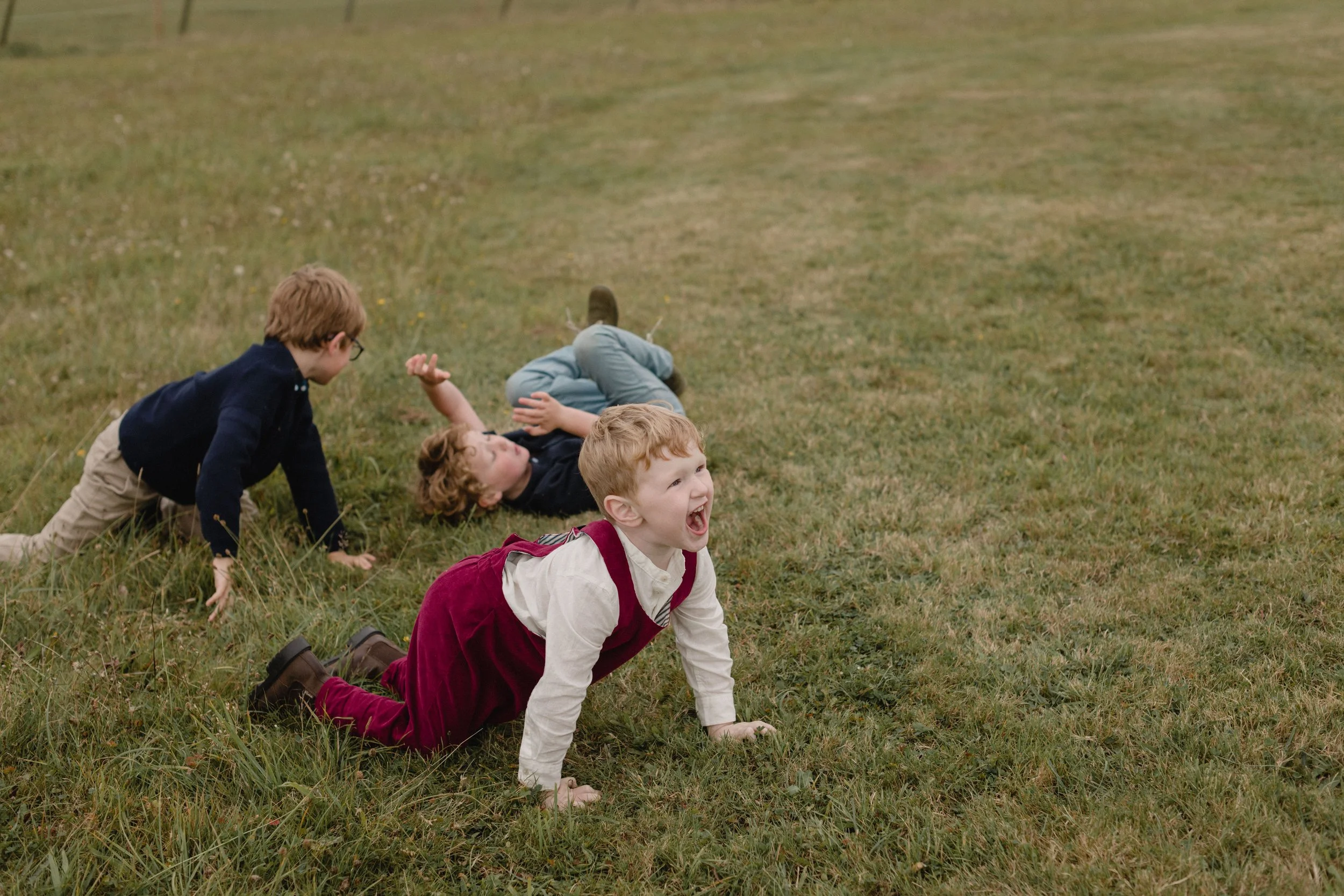 fun and candid toddler playing at Wembury wedding field
