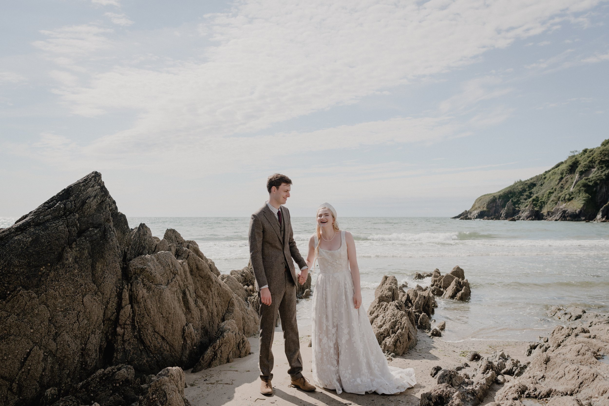 Fun and relaxed romantic couple photos by natural documentary wedding photographers from Cornwall on a Devon beach in the autumn