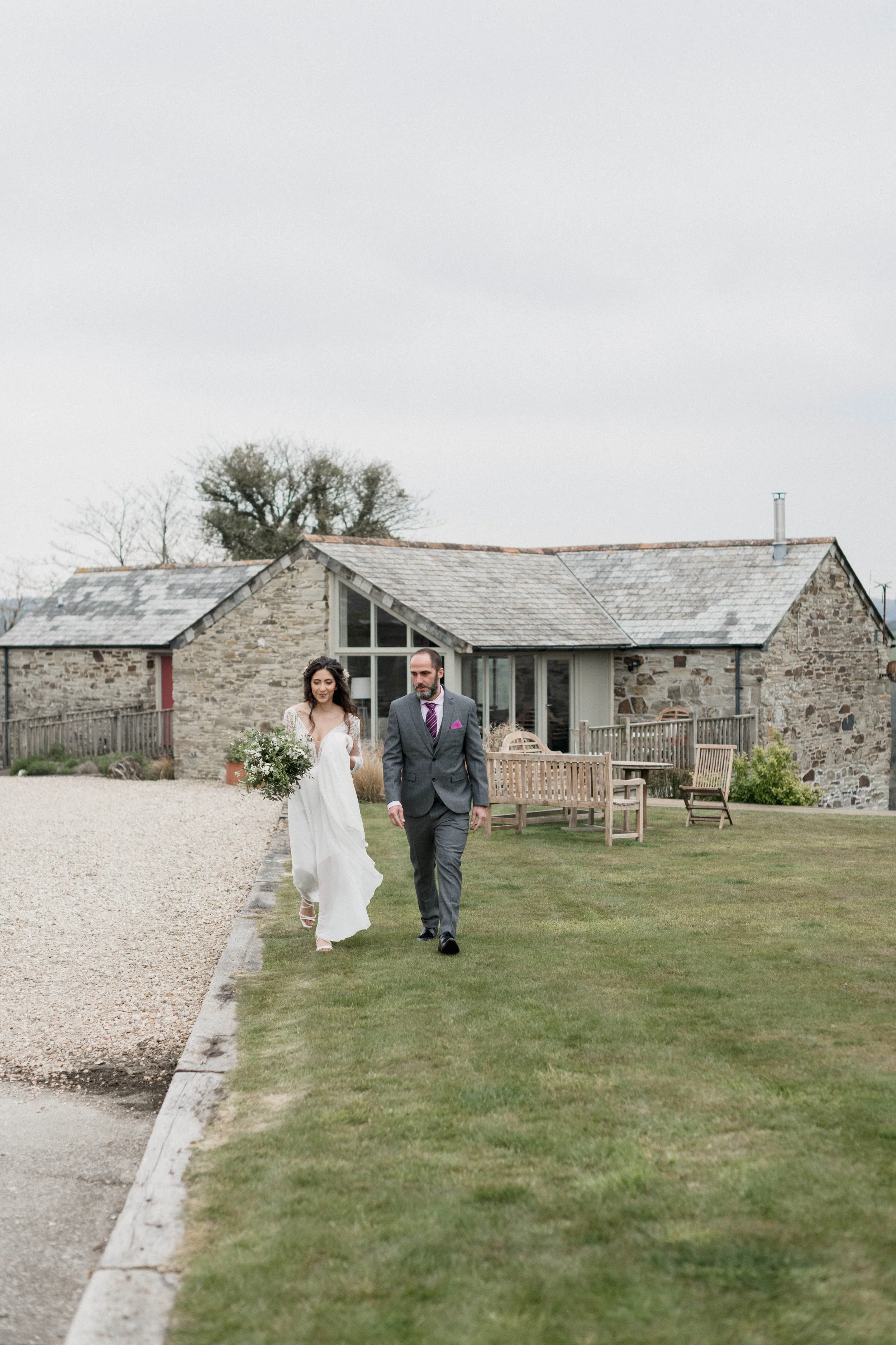 Reportage wedding photography of bride and father walking to intimate ceremony at camel studio