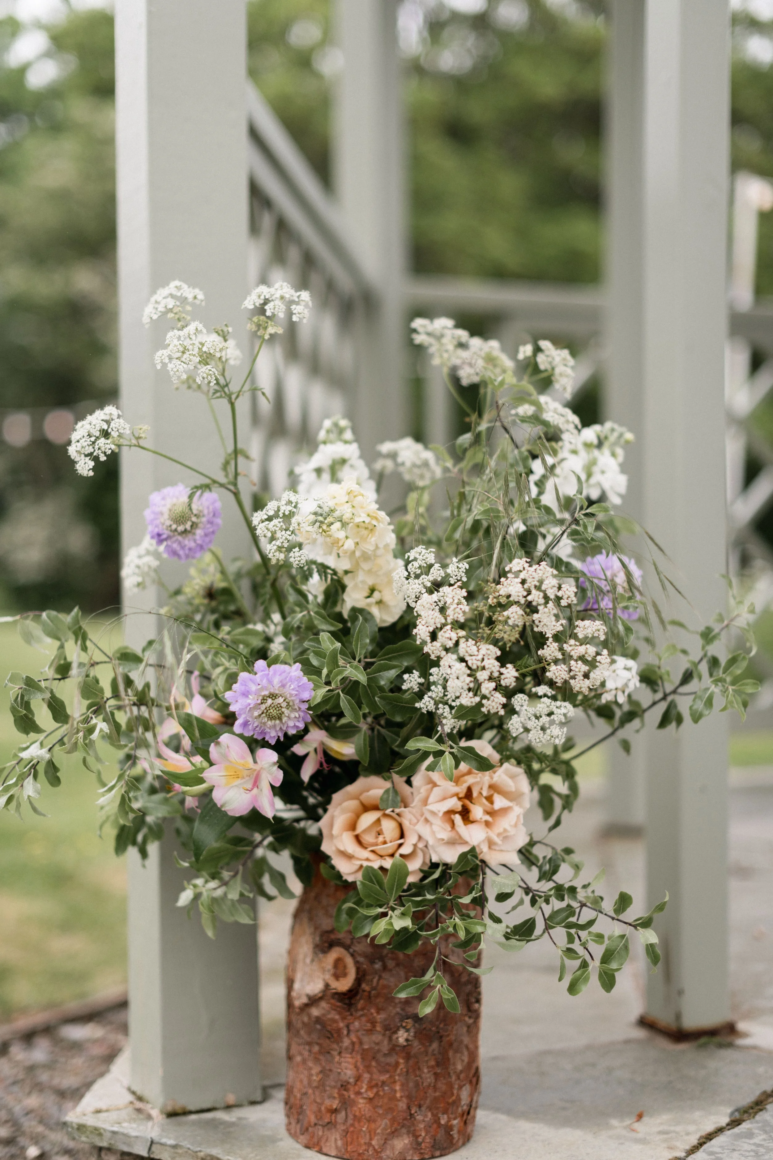 soft and whimsical spring meadow flower arrangement for rustic outdoor wedding