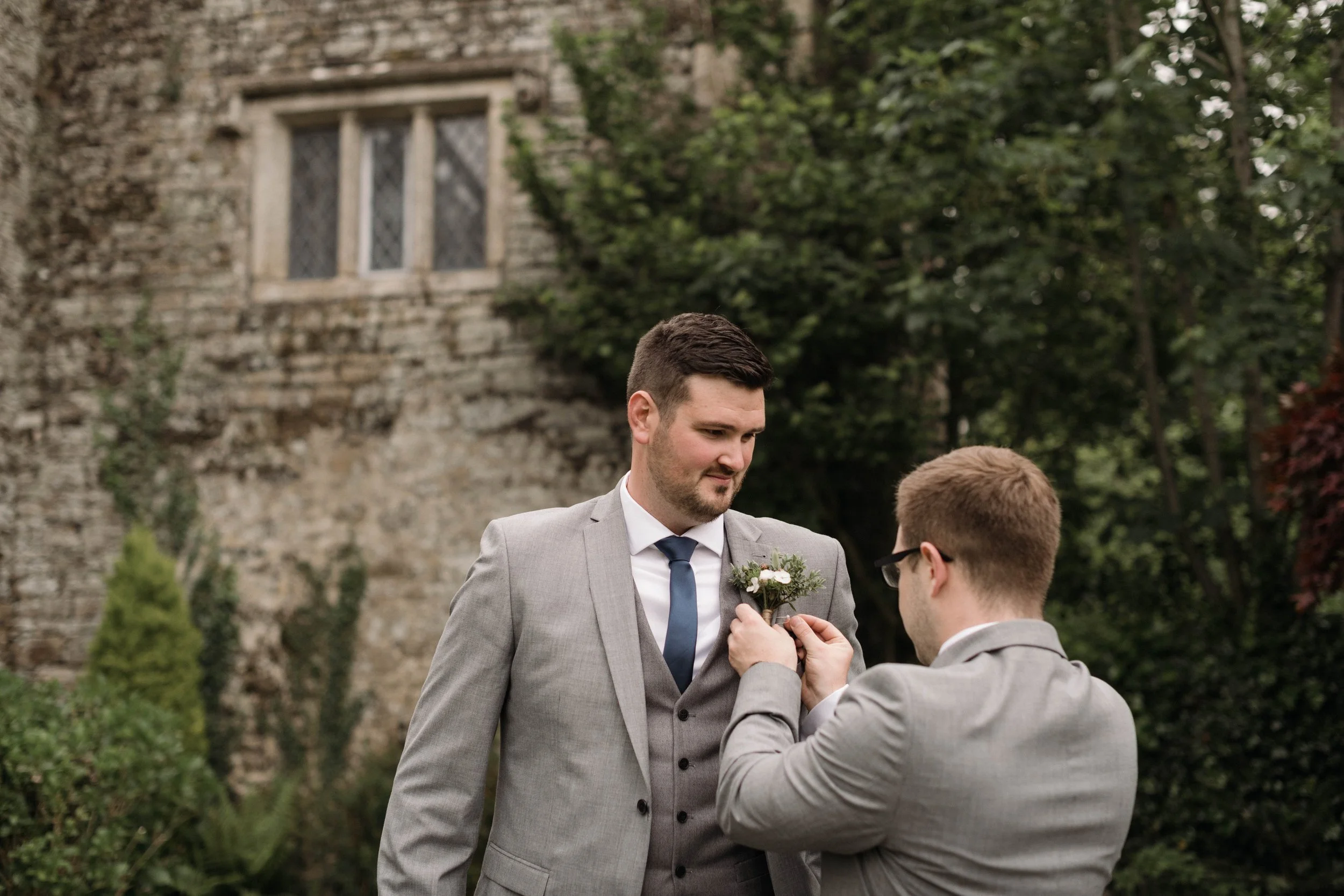 Reportage wedding photography of groom and groomsman getting ready for their cornwall wedding