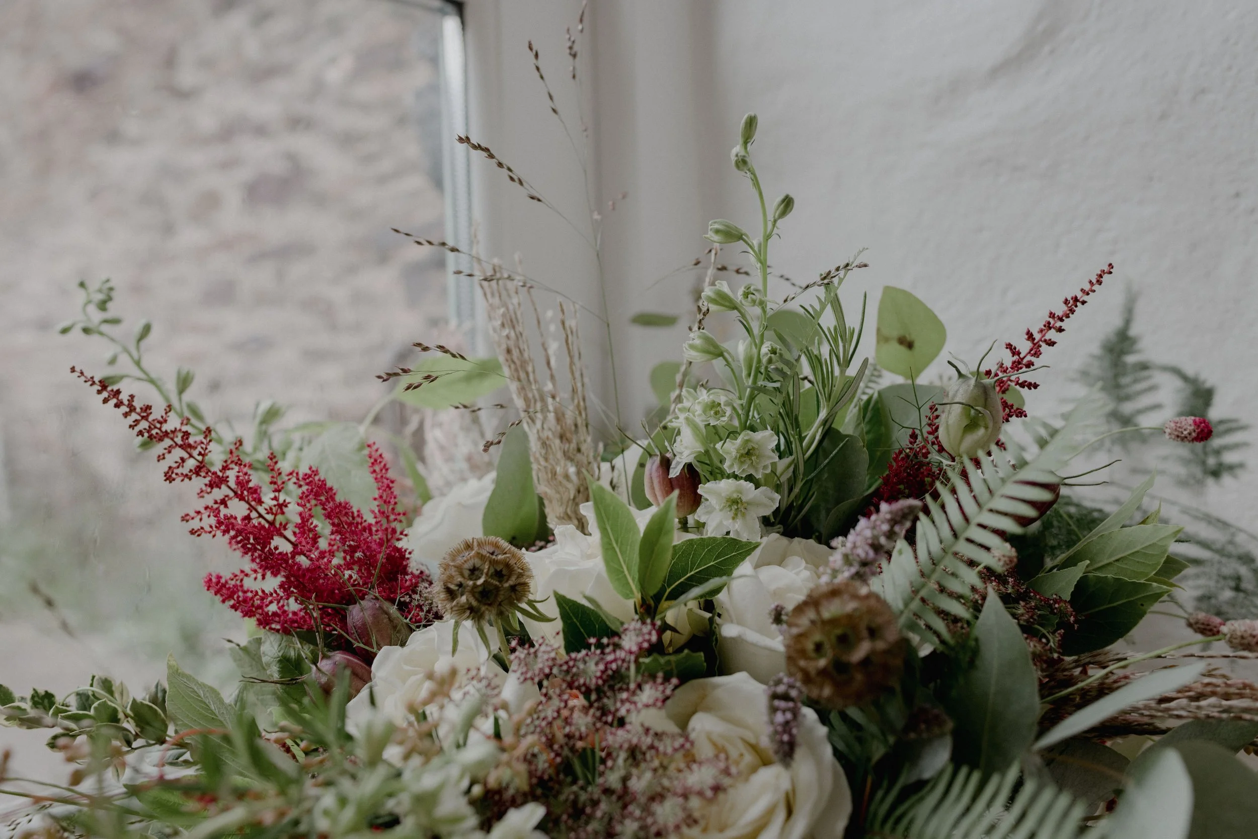rustic and wild wedding flowers with pinks and green foliage by HWatts florist