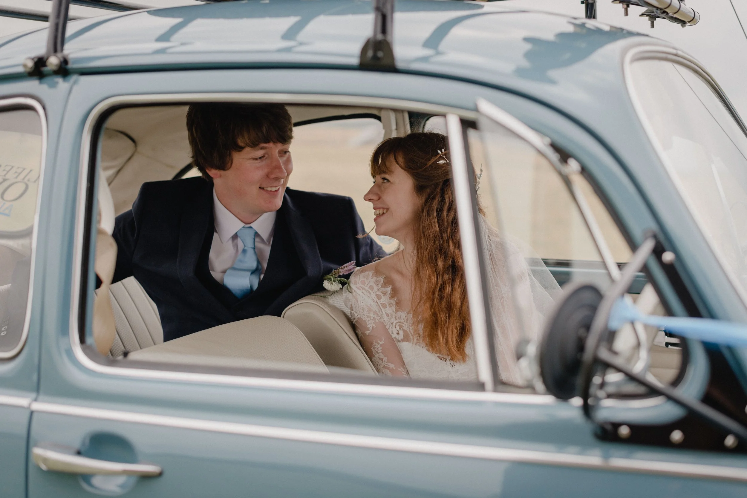 creative natural documentary wedding photography of couple in a VW beetle at their intimate seaside wedding in devon
