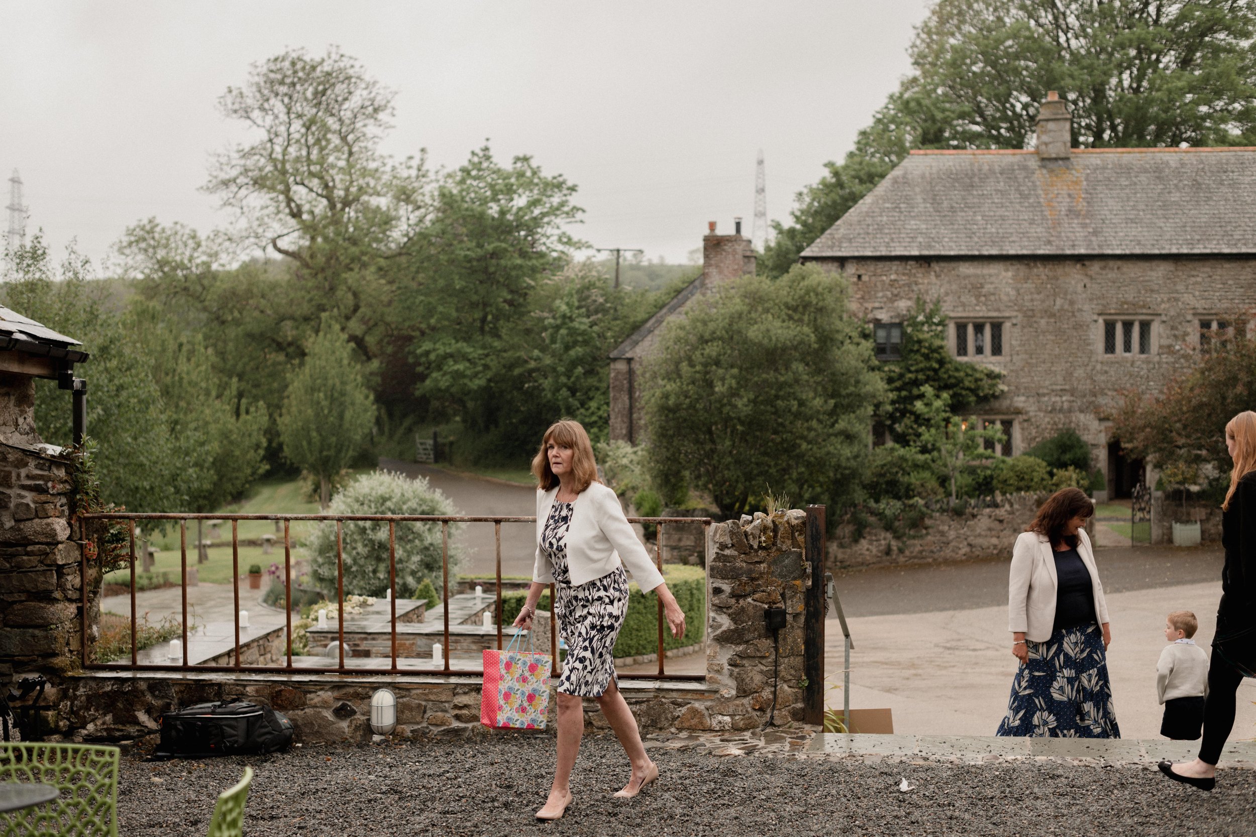 intimate wedding photographers capture natural documentary photos at old manor outdoor wedding venue in cornwall on a rainy day