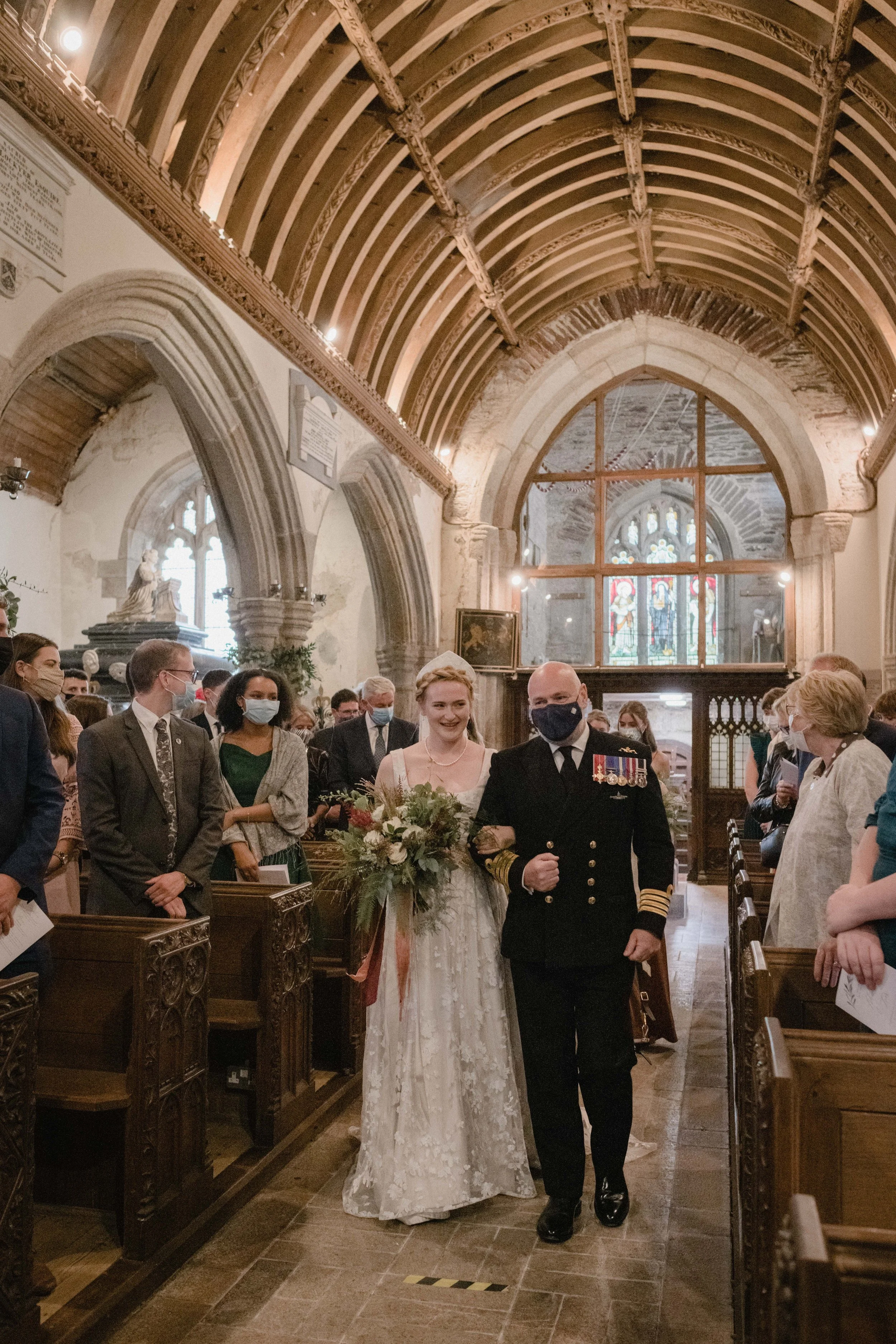 candid wedding photography moments of bride coming down the aisle at St Werburgh's church in Wembury